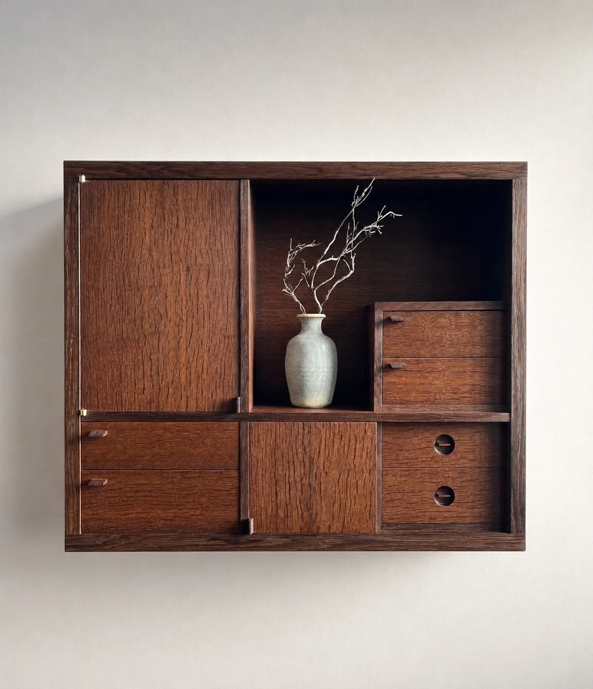 My first landscape-format wall cabinet, or wall tansu cabinet.

Using the lighter-toned bog oak from the centre of the boards revealed a beautifully subtle rift-cut figure throughout the piece. The cabinet features six drawers and two doors &mdash; o