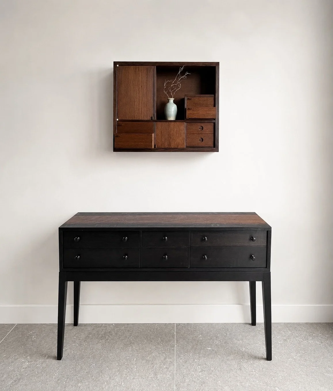A view of my landscape bog oak Tansu cabinet with a six-drawer bog oak console beneath it.

Although the form of the console appears simple at first glance, each drawer is actually a different proportion. The apparent uniformity is quietly disrupted 