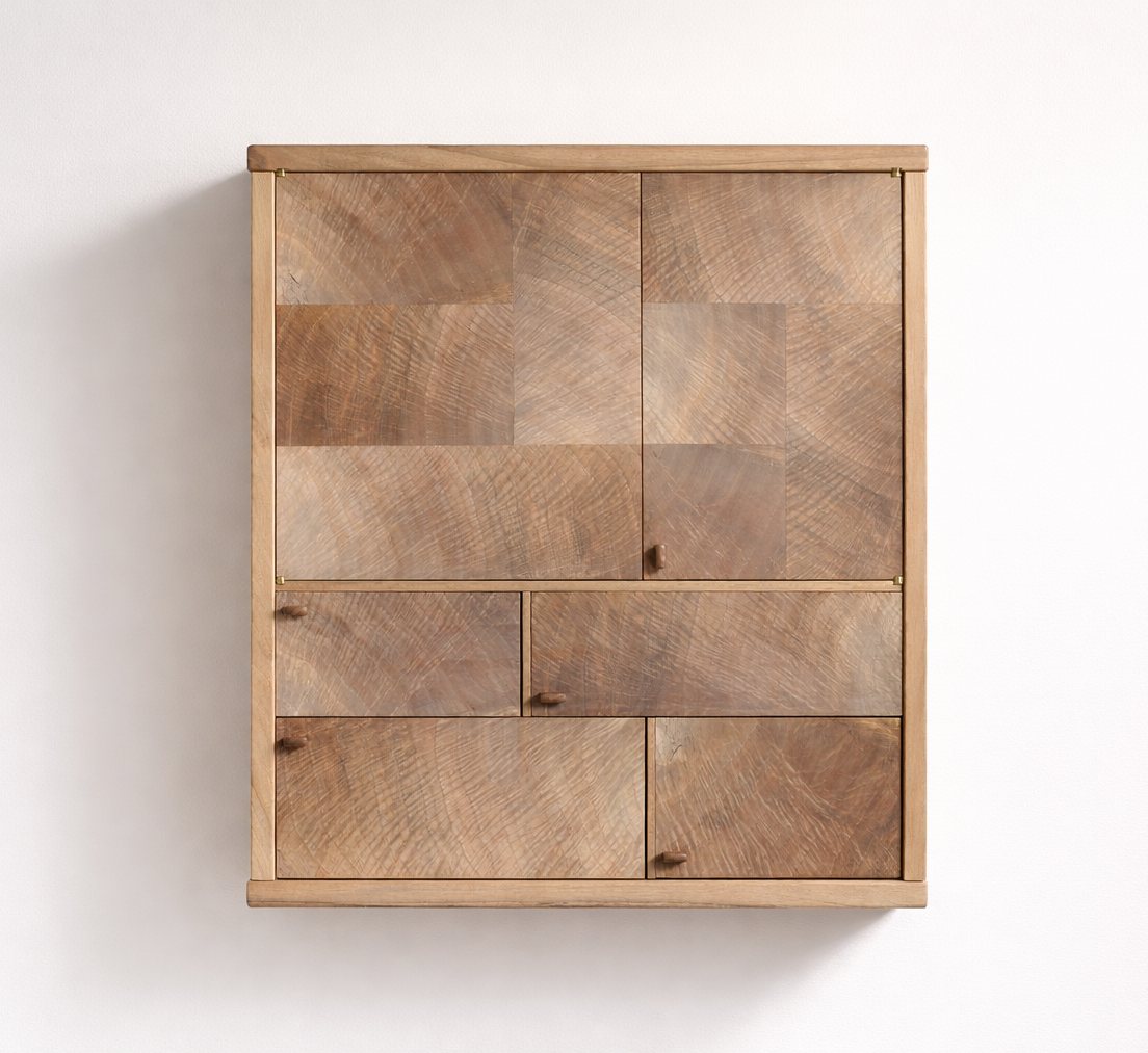 Wooden cabinet with multiple drawers and doors, set against a plain white wall.
