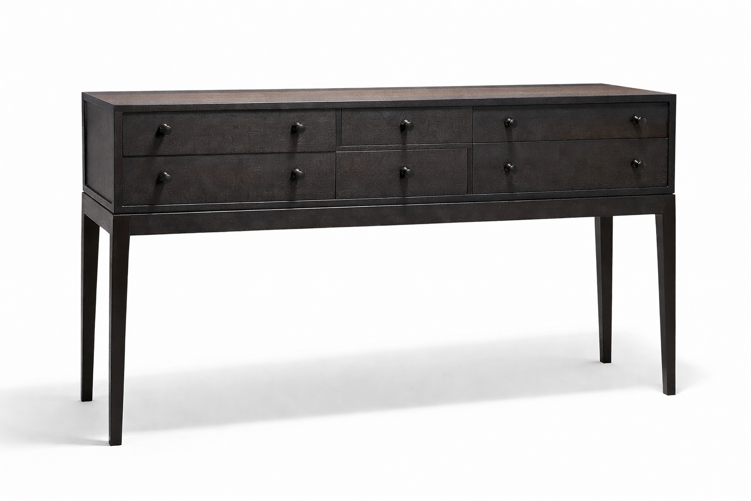 Dark wooden dresser with six drawers and small round knobs, standing on four tapered legs.