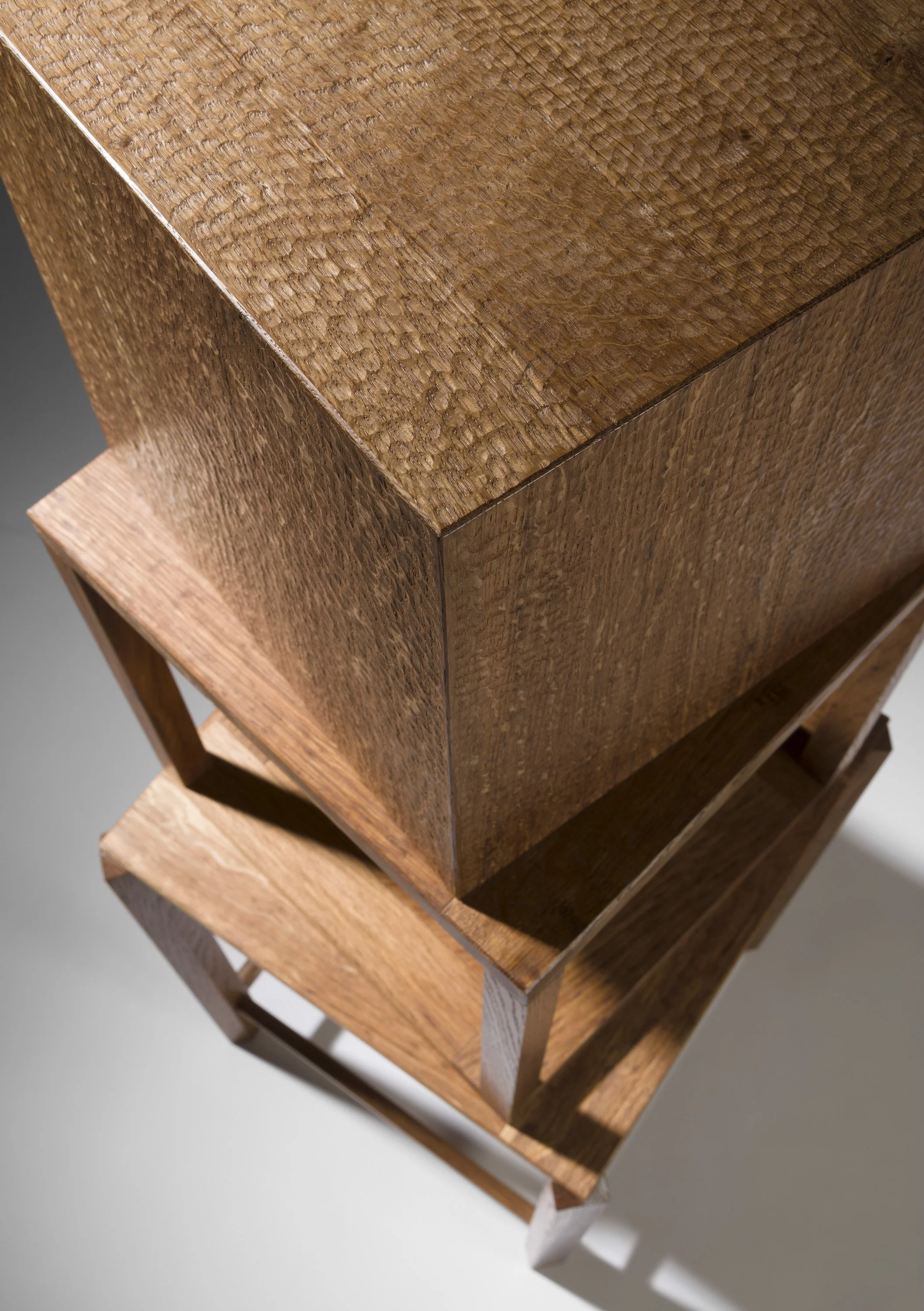 Close-up view of a wooden display stand showcasing its textured surface and different shades of brown wood.
