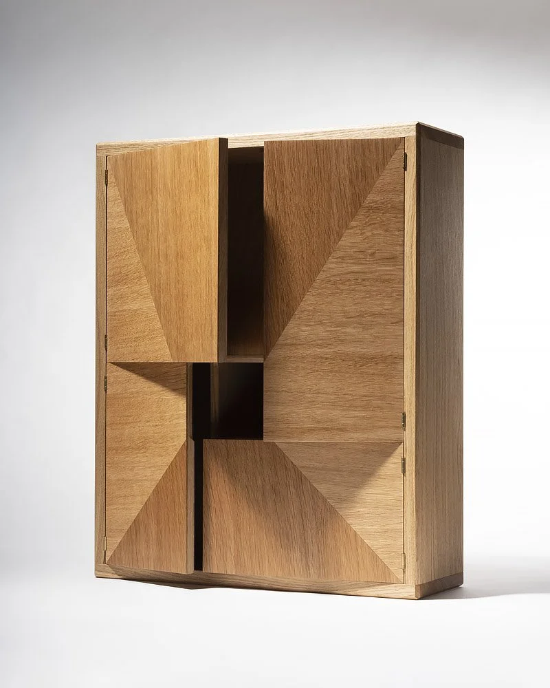 A modern wooden cabinet with geometric panel design, standing against a plain gray background.