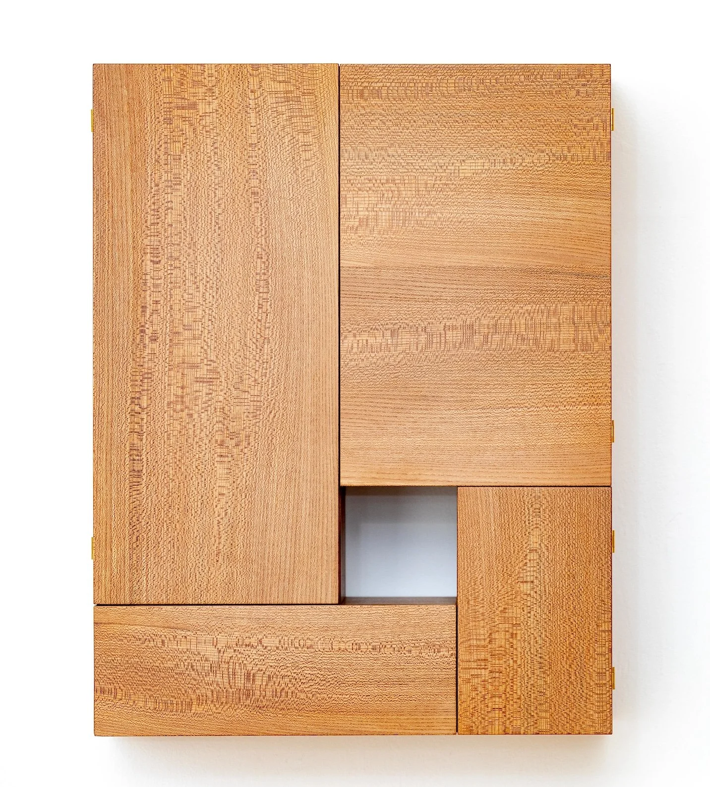 A wooden cabinet with multiple rectangular compartments and a small, open square in the center, set against a white background.