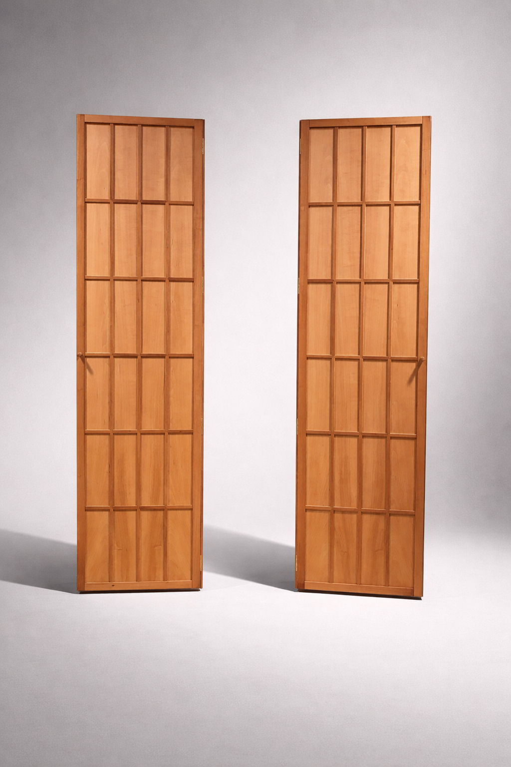 Two wooden cabinets against a plain gray background.