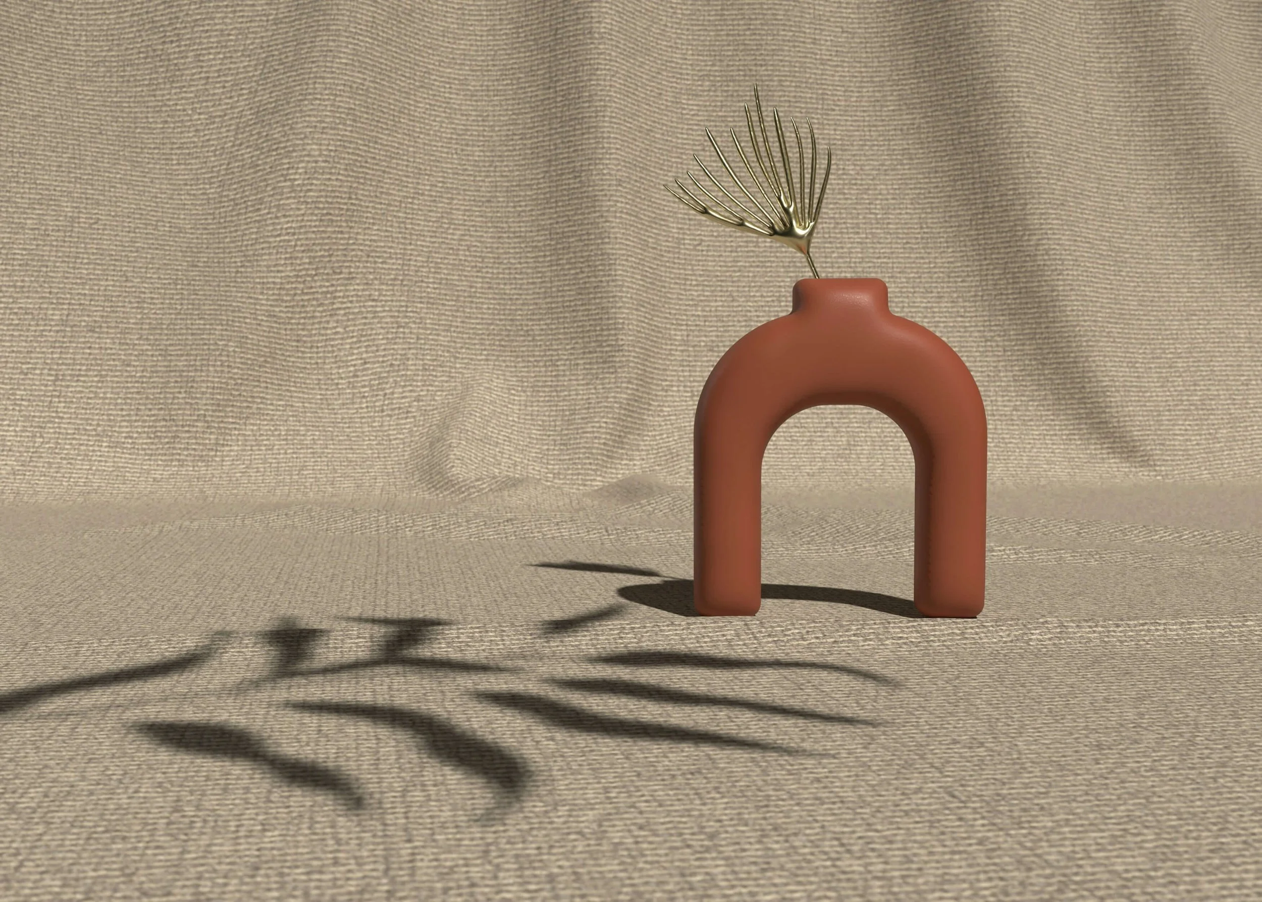 Decorative clay arch-shaped vase with a gold metal fern leaf on a textured beige background, casting shadows.
