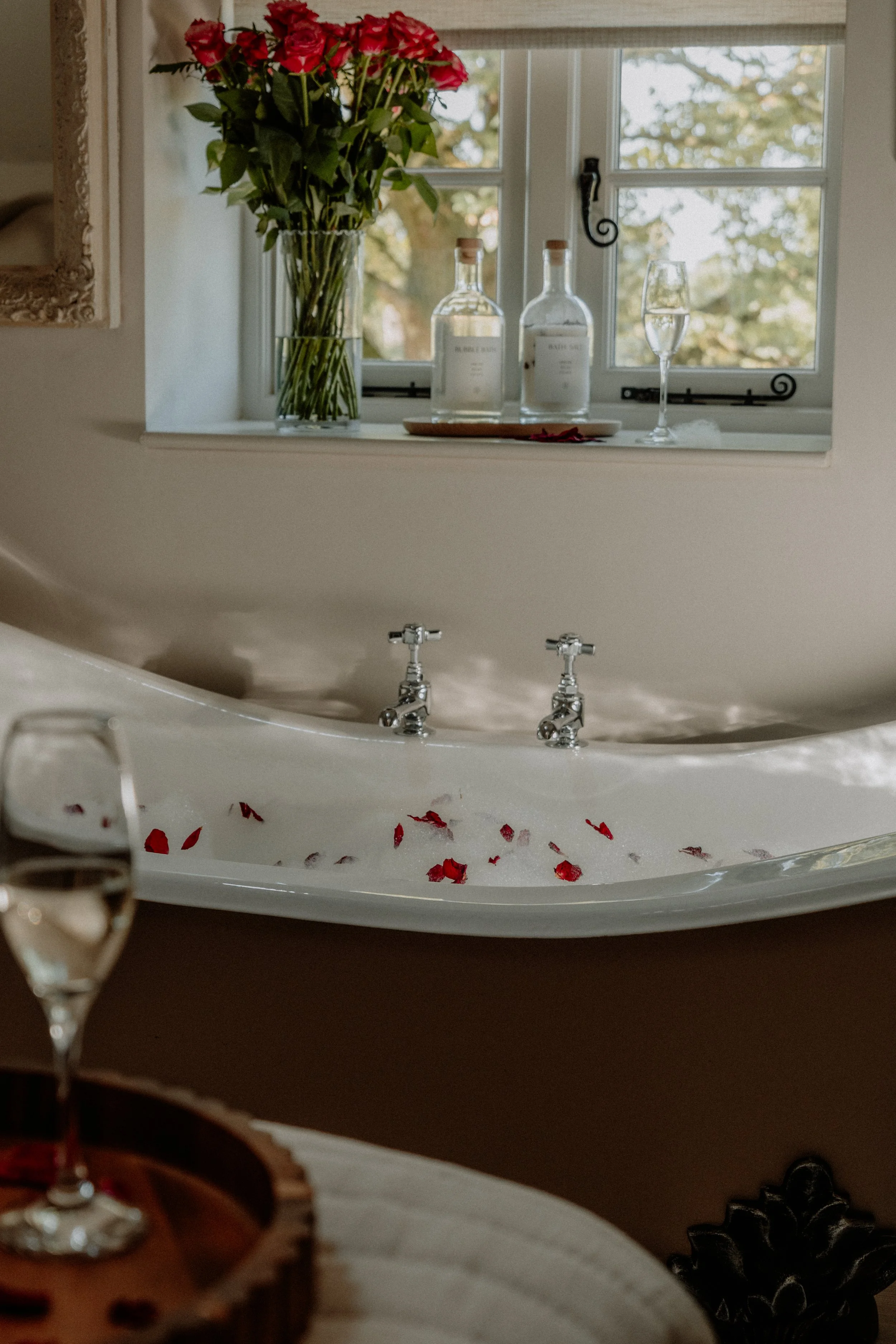 Rose petals ready to scatter in the bath for a romantic stay at Cedar Cottage