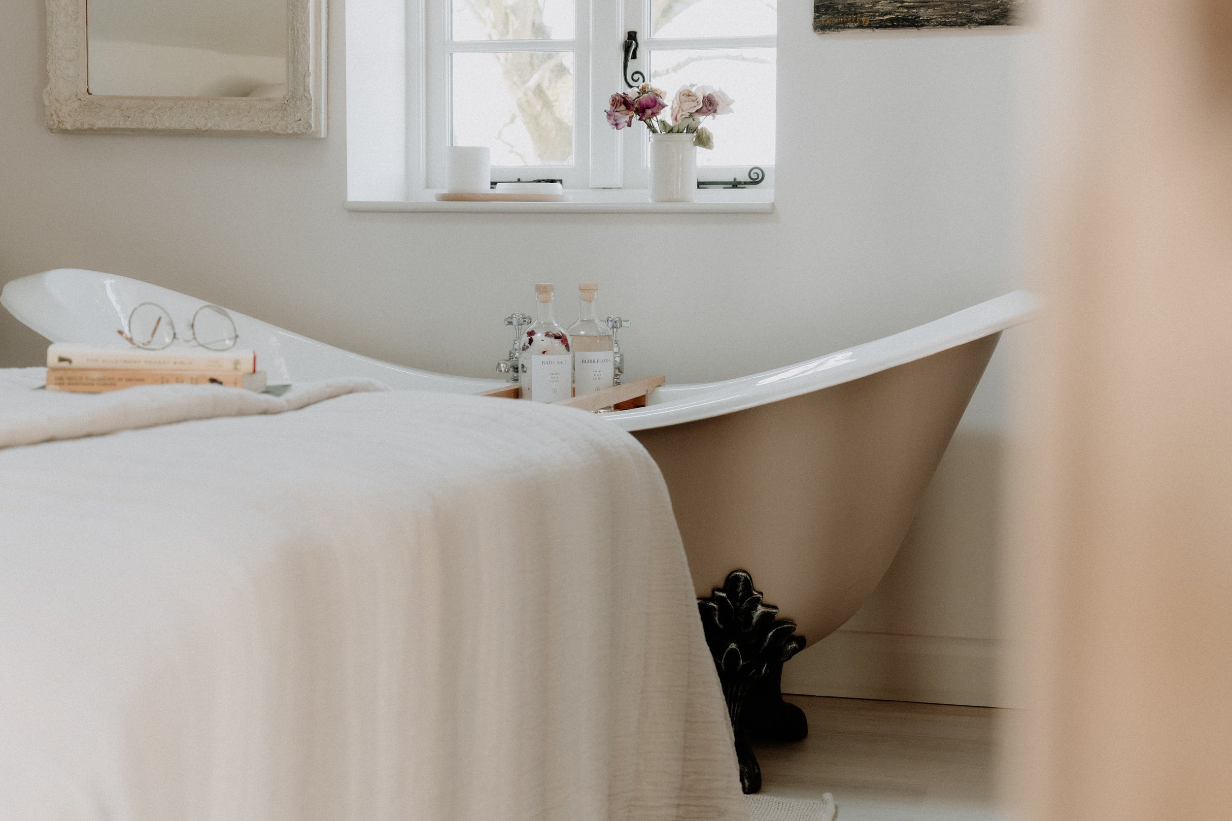 Roll-top bath in the bedroom at Cedar Cottage