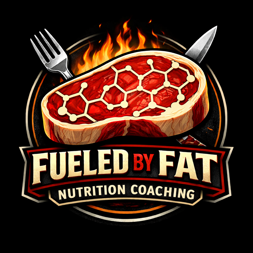 A logo featuring a steak with a molecular pattern on top, flames in the background, and a fork and knife. The text reads 'Fueled by Fat Nutrition Coaching'.