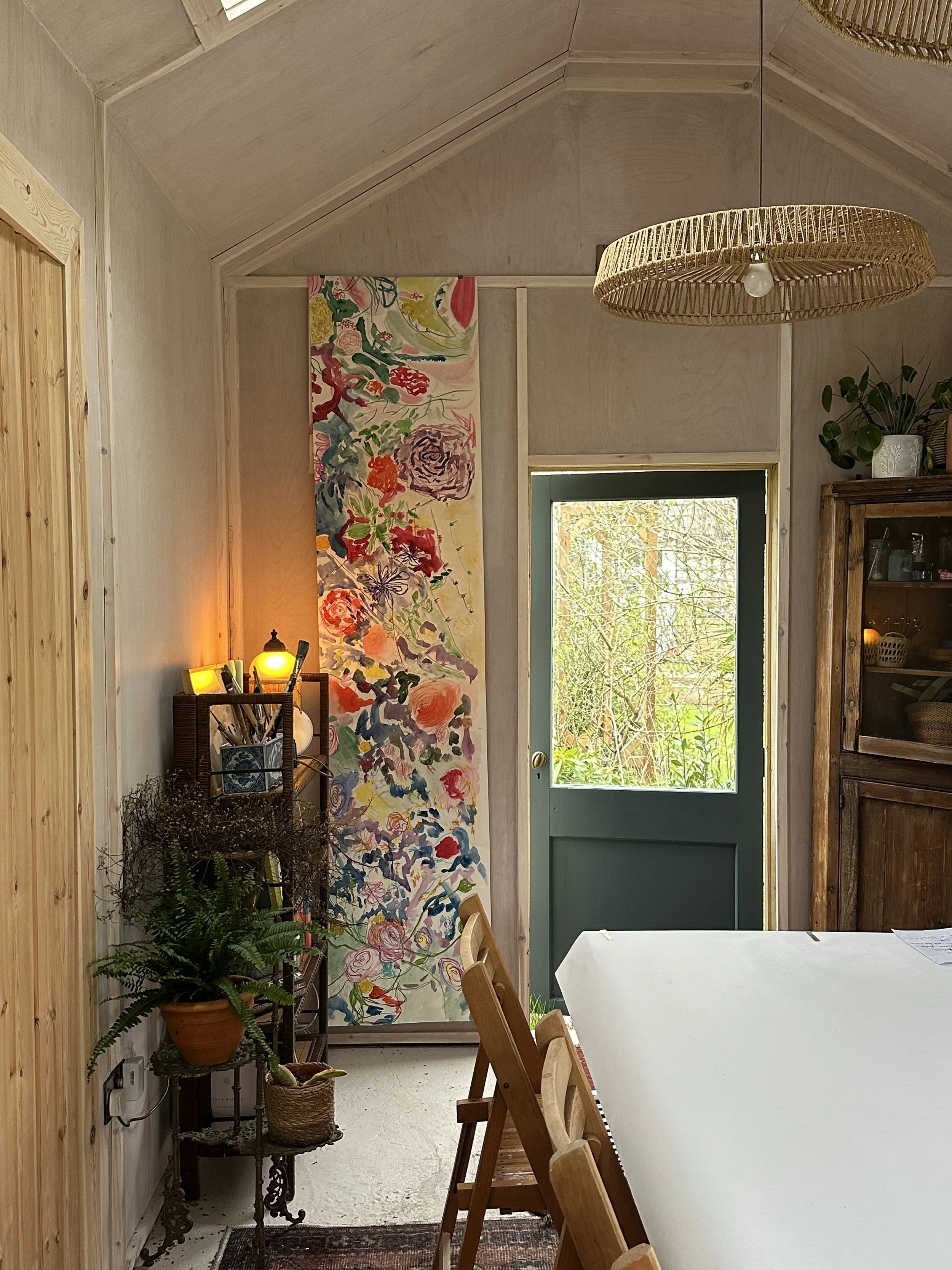 The Creative Pause studio - based in Norwich - a calm and serene workshops space with a large table down the centre and refined bohemian interiors - also an example of the communal painting is displayed on one wall