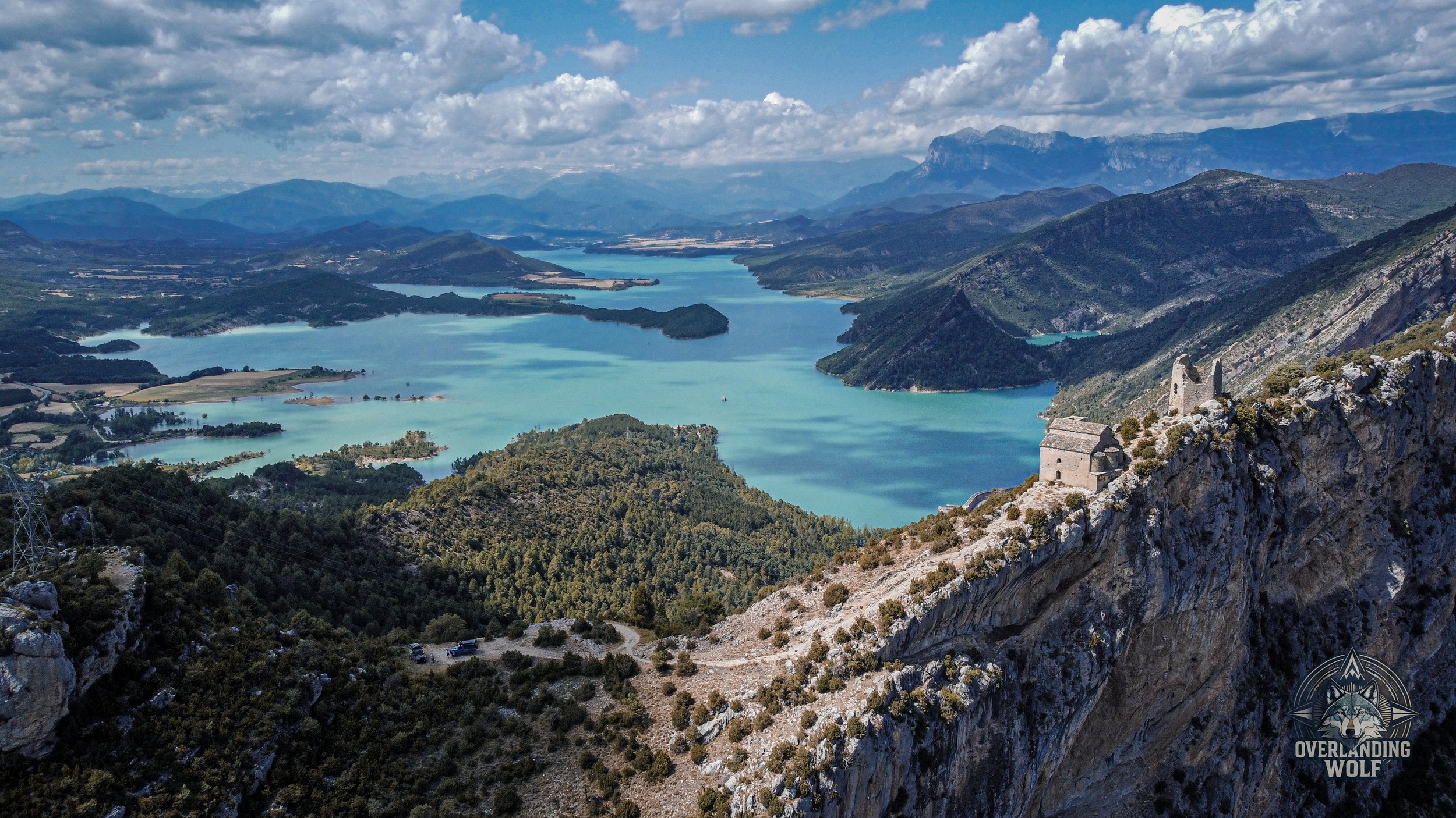 Turquoise lake and mountain ruins in the Spanish Pyrenees