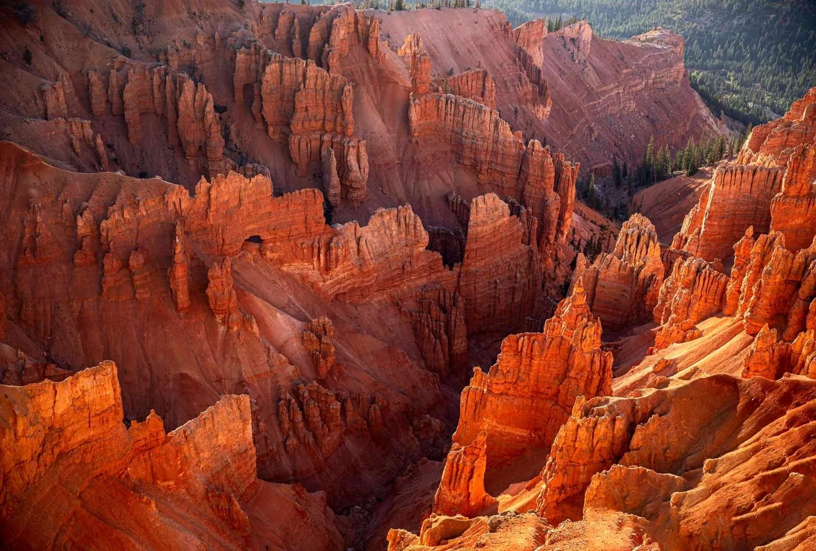 Cedar Breaks National Monument: Spires of jagged rock jut up from the canyon floor, striped with reds, yellows, and browns.