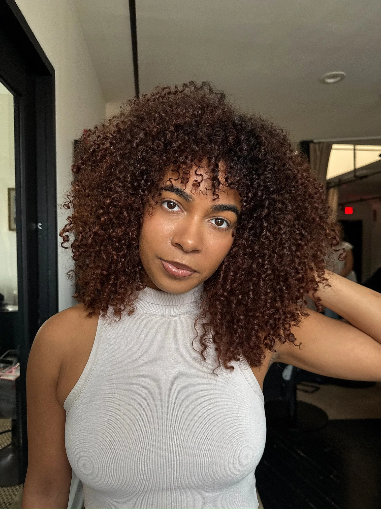 deep brown red curly hair with bangs