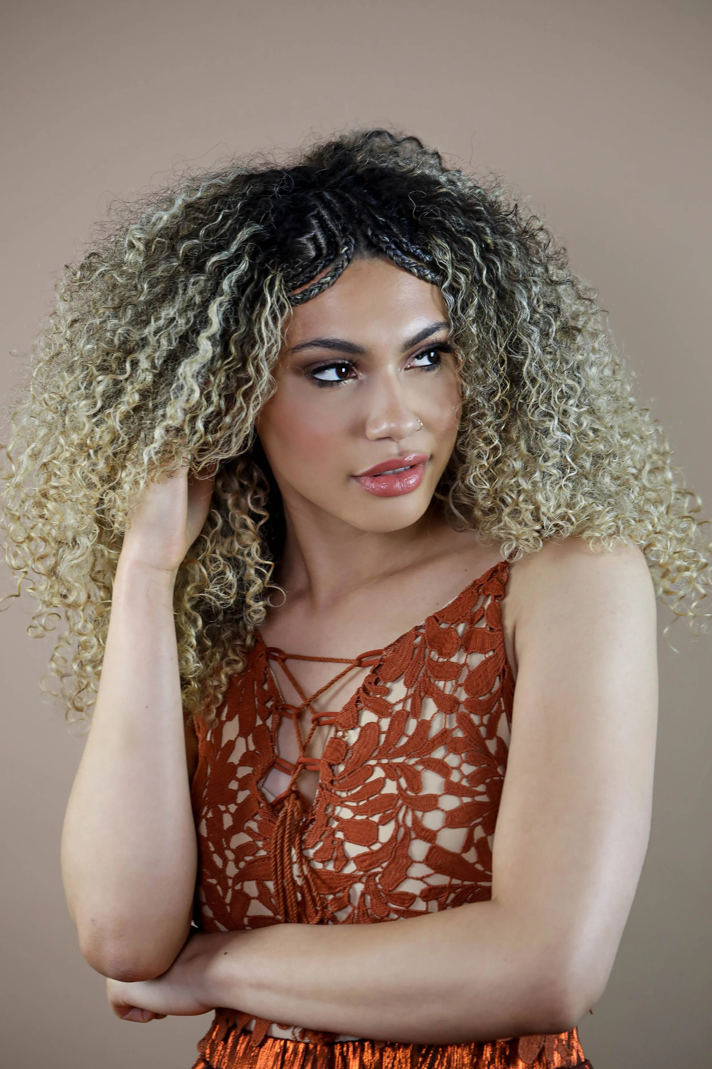 long curly dimensional blonde hair with cornrow braids on parting