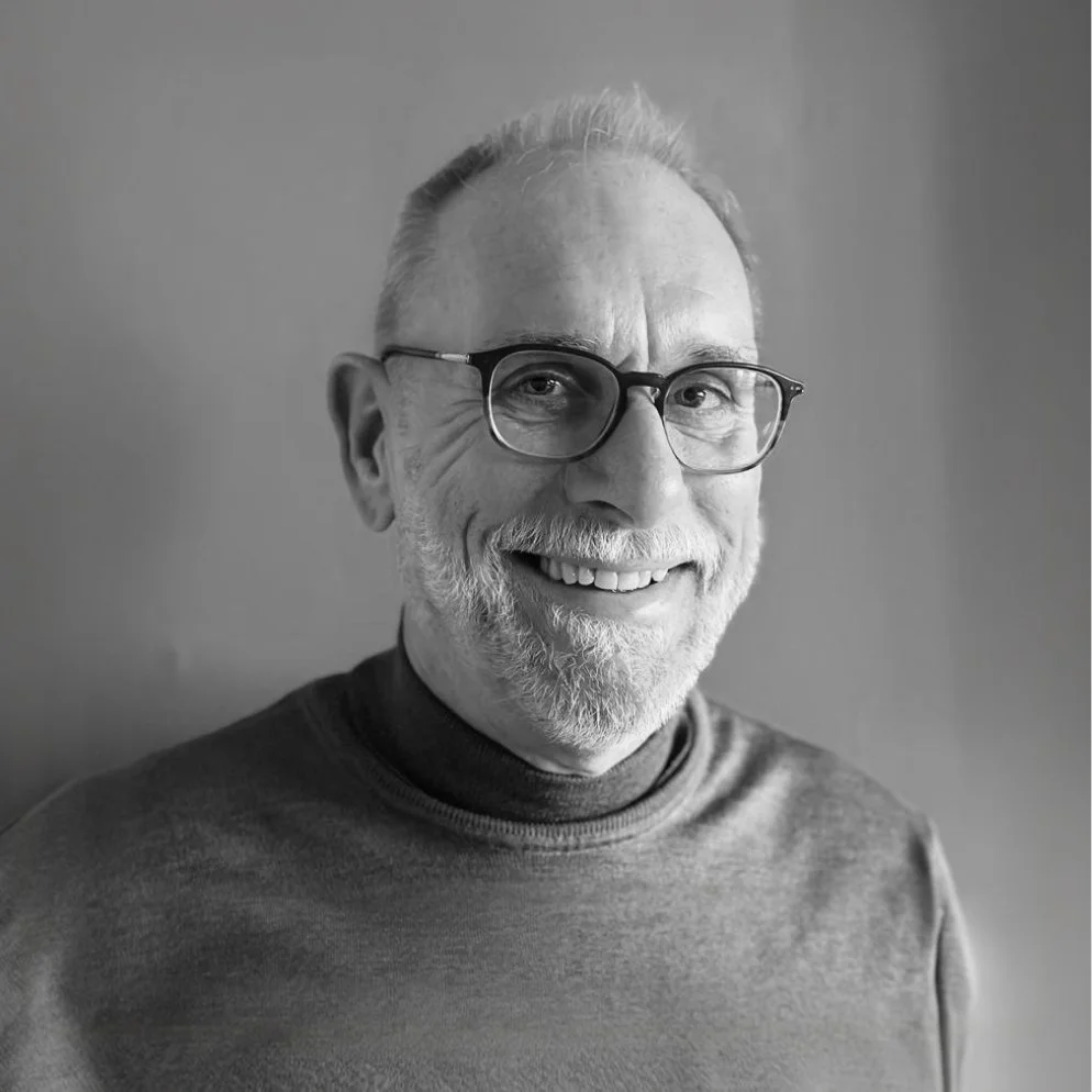 Headshot of smiling male tutor with medium-length black hair wearing a lanyard.