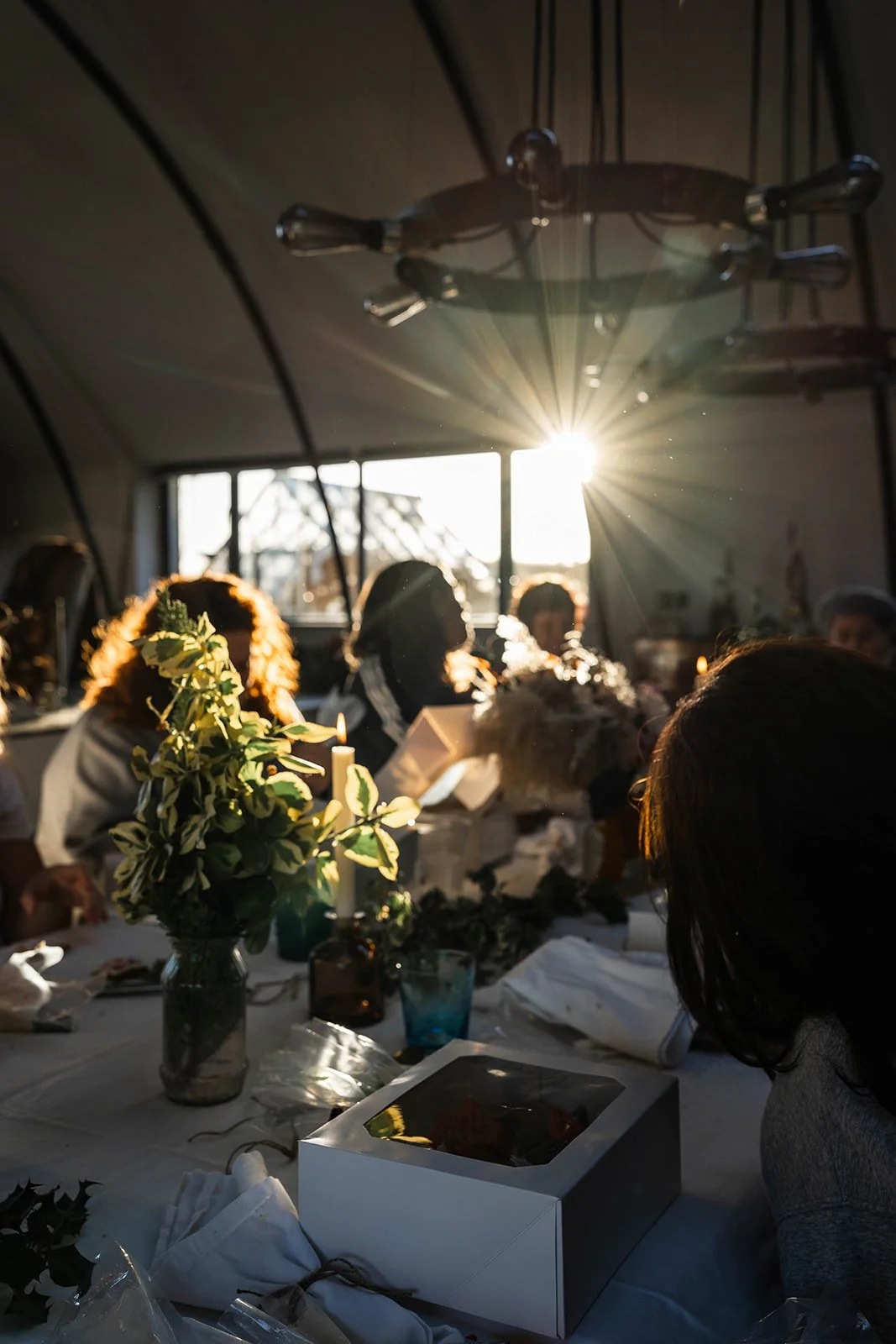 feasting table layout in the sun, people having a good time socialising