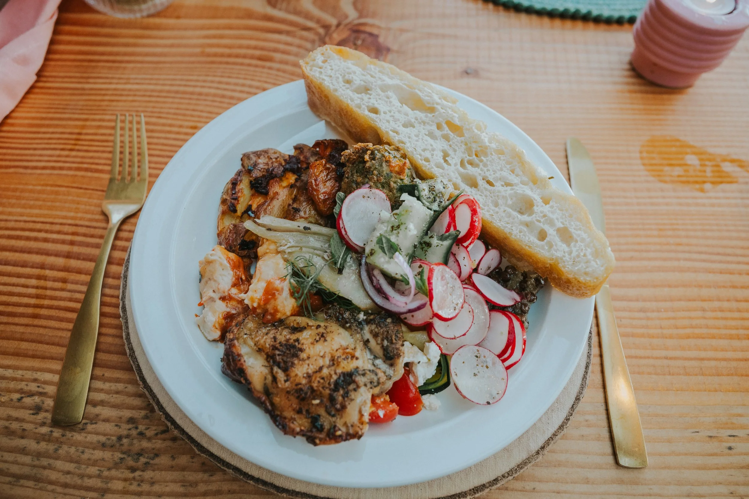 colourful feasting plate at the table with selection of catering food, chicken dish, salad, bread, healthy fresh and vibrant