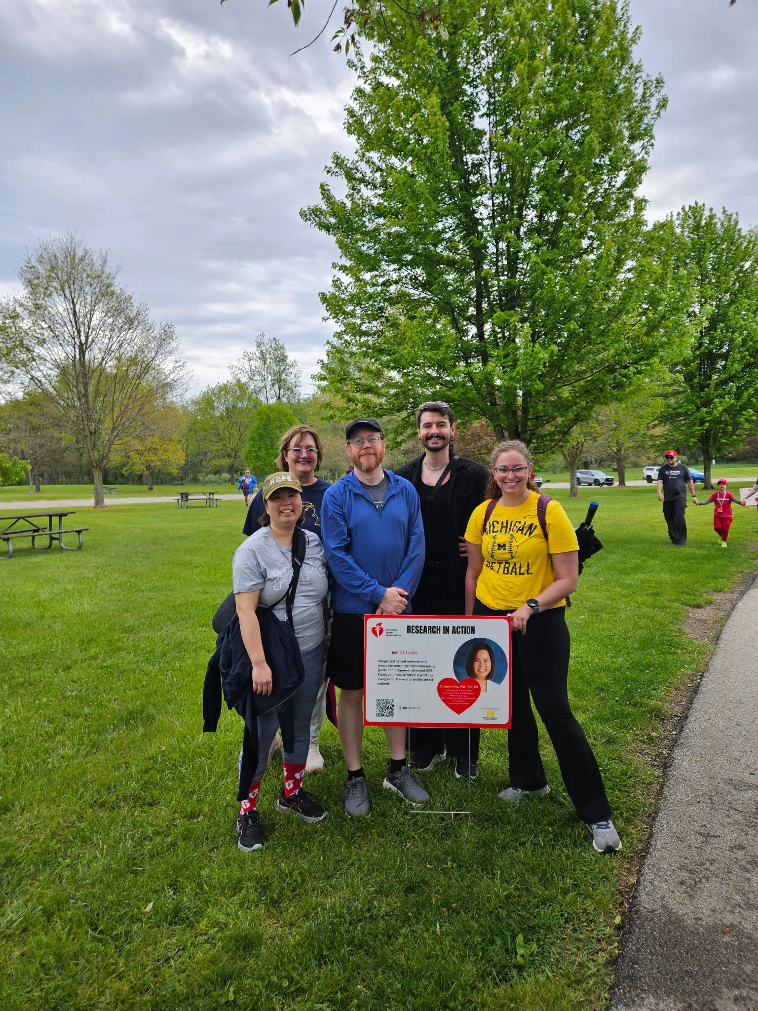  At the Heart and Stroke Walk, members of the INSIGHT-CPR team pose next to a sign describing INSIGHT-CPR. In front: Dr. Cindy Hsu (left), Jay Semerad, and Courtney Dennis. In back: Jennifer Fowler and Peter Walczyk. 