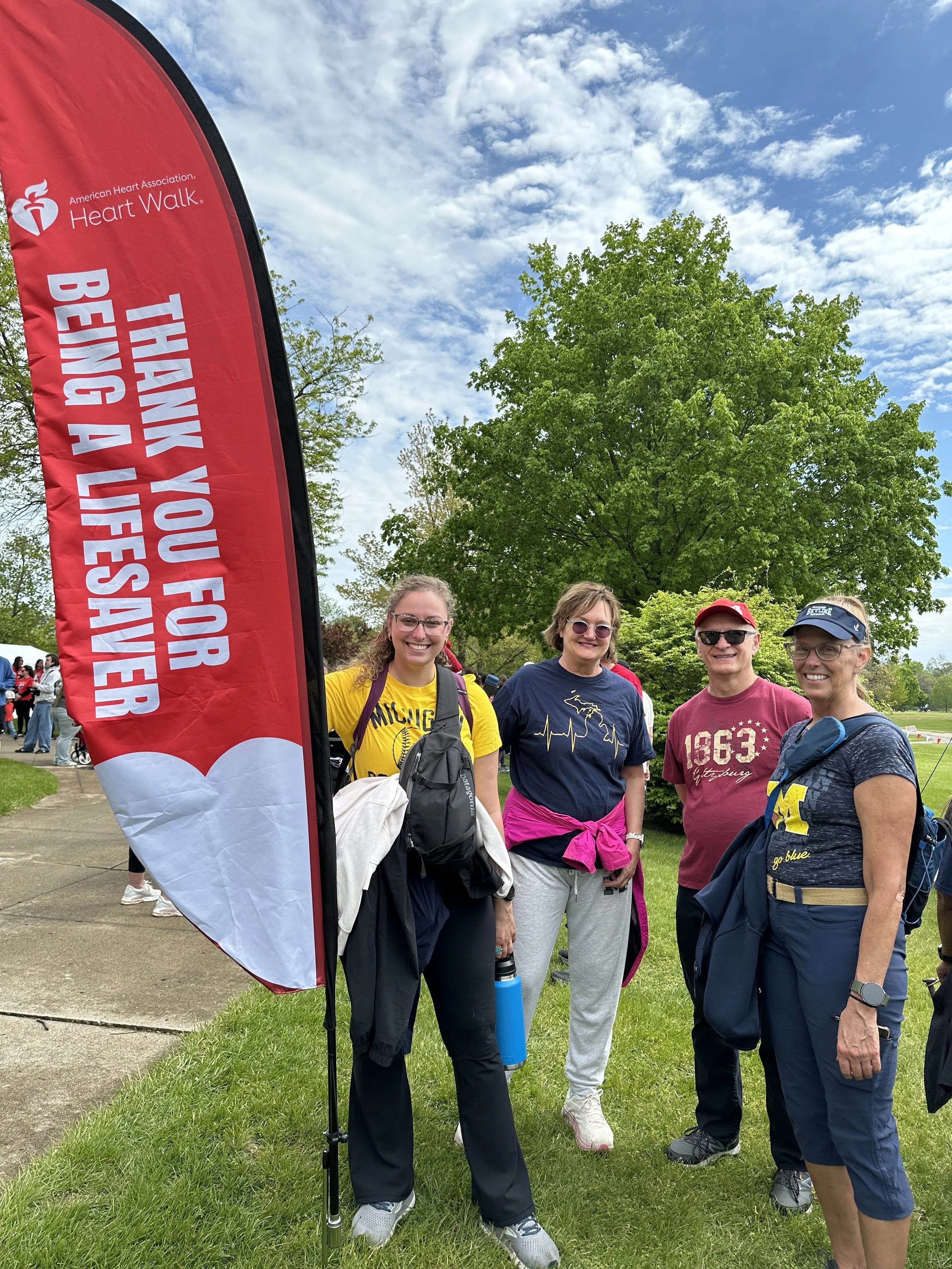  Members of the INSIGHT-CPR team pose next to a promotional banner for the Heart and Stroke Walk 