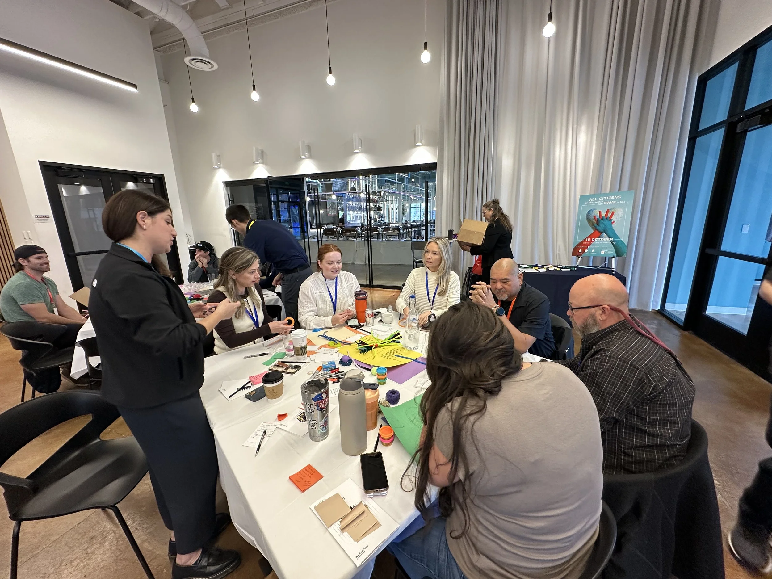 Members of the INSIGHT-CPR team and invited end-users, (including police, EMS, firefighters, and clinicians), performing a group activity during the October 2025 design-thinking workshop.