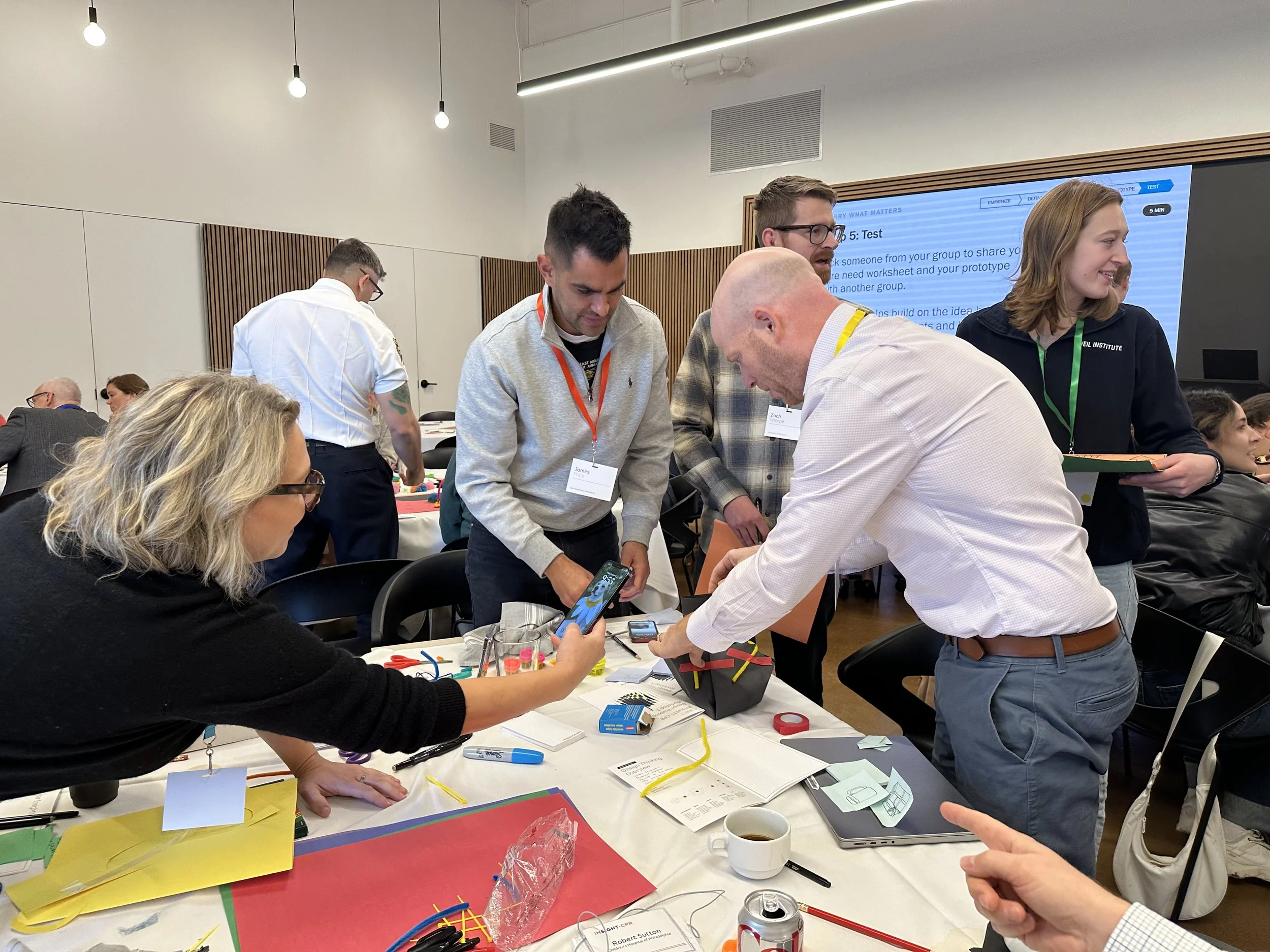 Members of the INSIGHT-CPR team and invited end-users, (including police, EMS, firefighters, and clinicians), performing a group activity during the October 2025 design-thinking workshop.