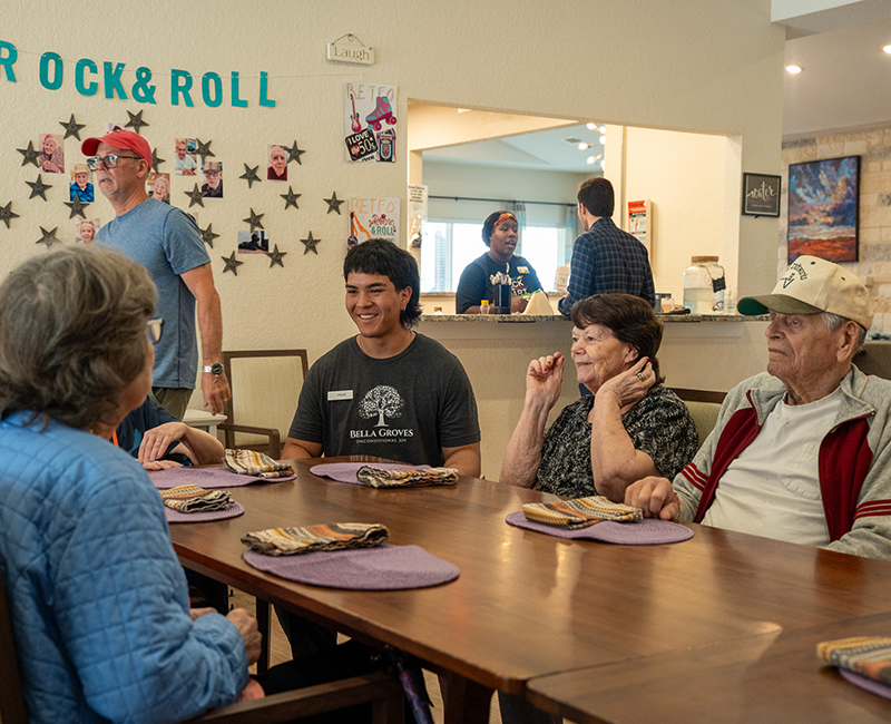 Bella Groves caregivers and residents enjoying a social activity in a warm, home-like residential dementia care and memory care community in Bulverde, Texas.