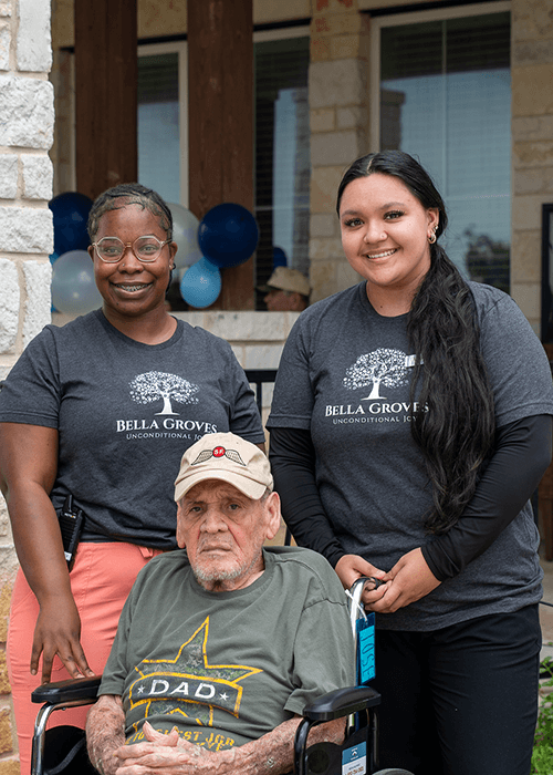Bella Groves caregivers smiling with a resident, reflecting the compassionate, relationship-centered approach to dementia care and assisted living.