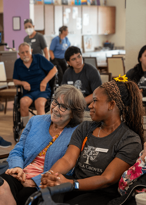 Bella Groves residents participating in a social activity with caregivers in a welcoming residential dementia care community in Bulverde, Texas.