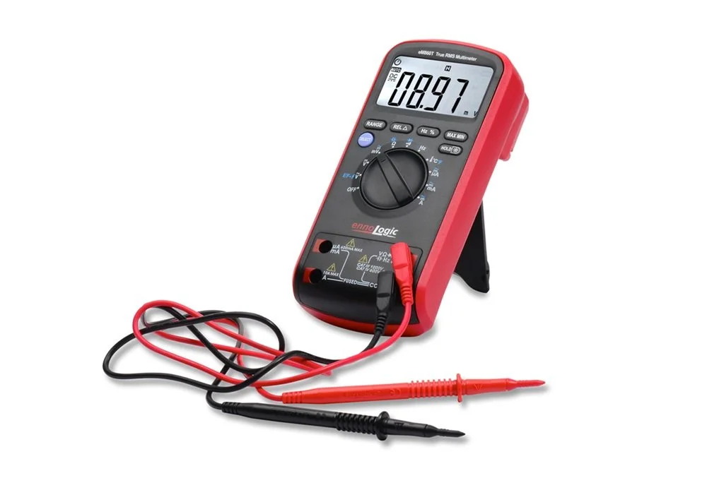 Digital multimeter with red and black probes, displaying a reading of 8.97, standing on a white background.