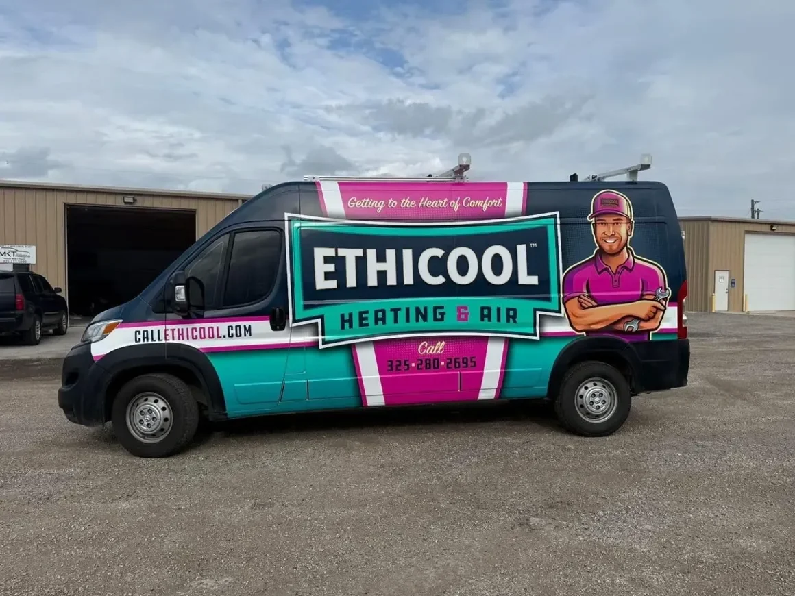 Company van for Ethicool Heating & Air with a colorful design, logo, website, and phone number, parked on a gravel lot with a building in the background.