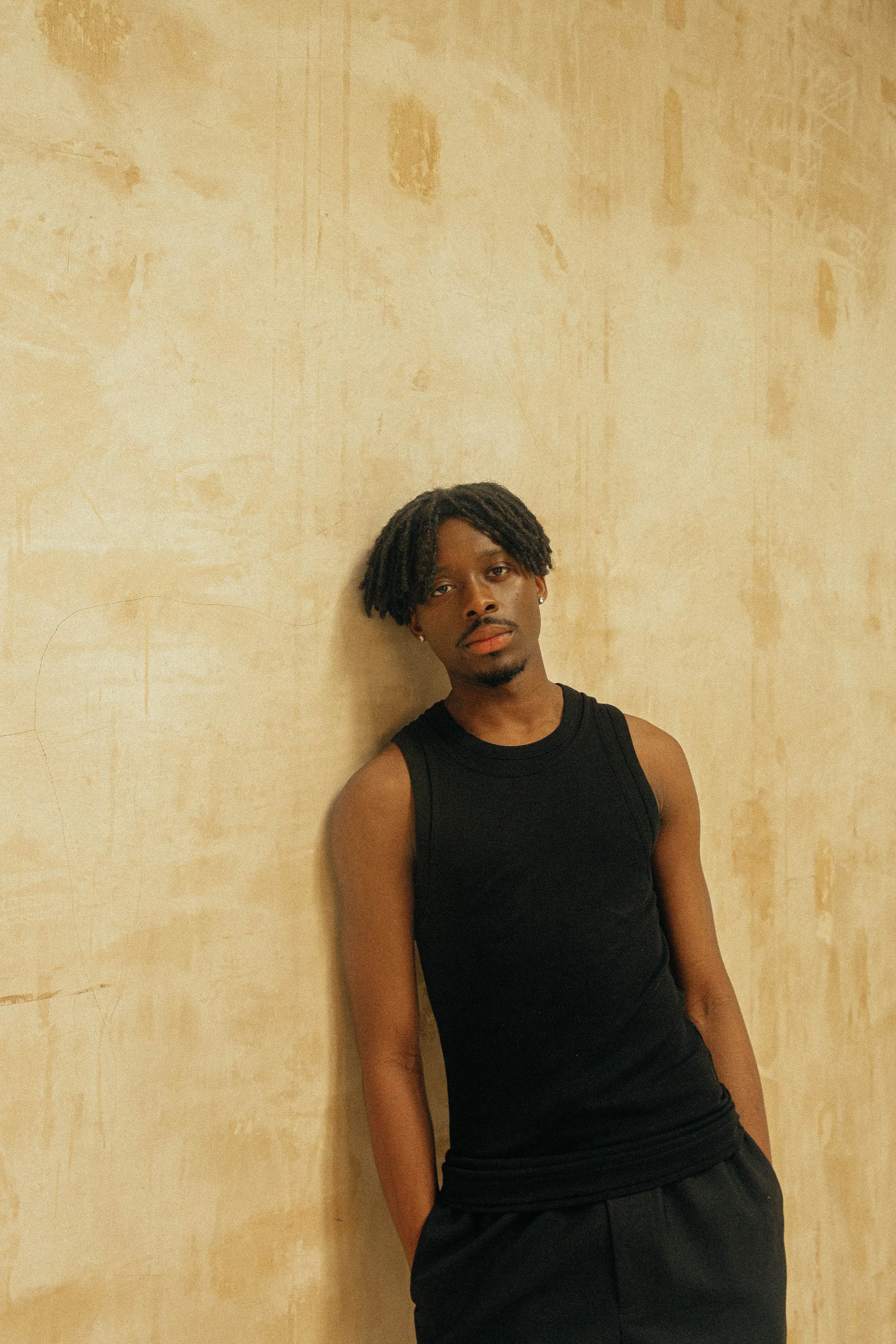   Images Above, Sheyi Cole wears: Vest: Qasimi, Herkimer Ribbed Jersey Double Layered Tank, Trousers: Qasimi | Purple PR  