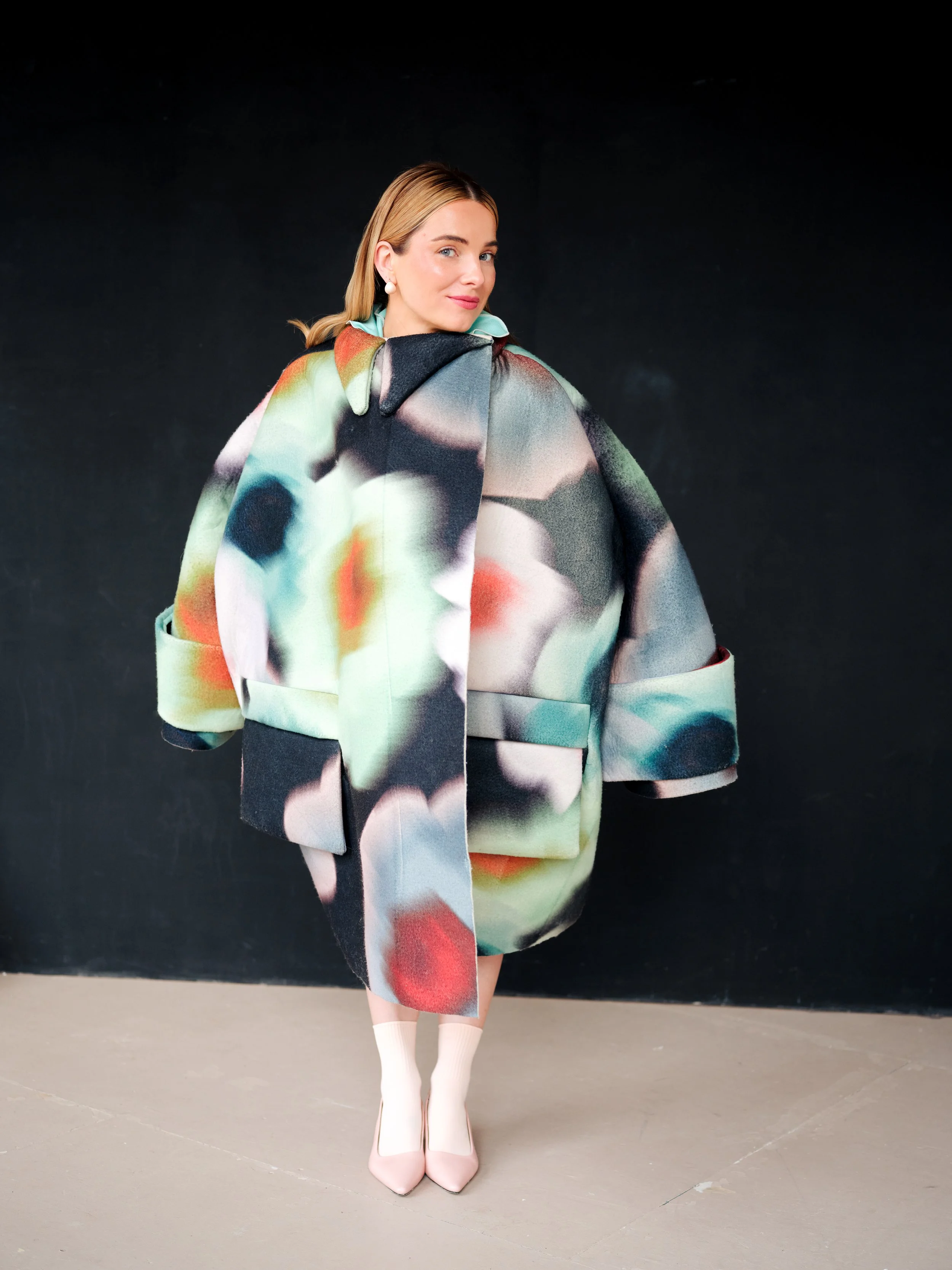   Image above and below, Siân Welby wears - Coat:    Hannah Dixie     | Dress:    Hanna Simone    | Earrings:    Broque London    | Shoes &amp; socks: Stylist’s archive  