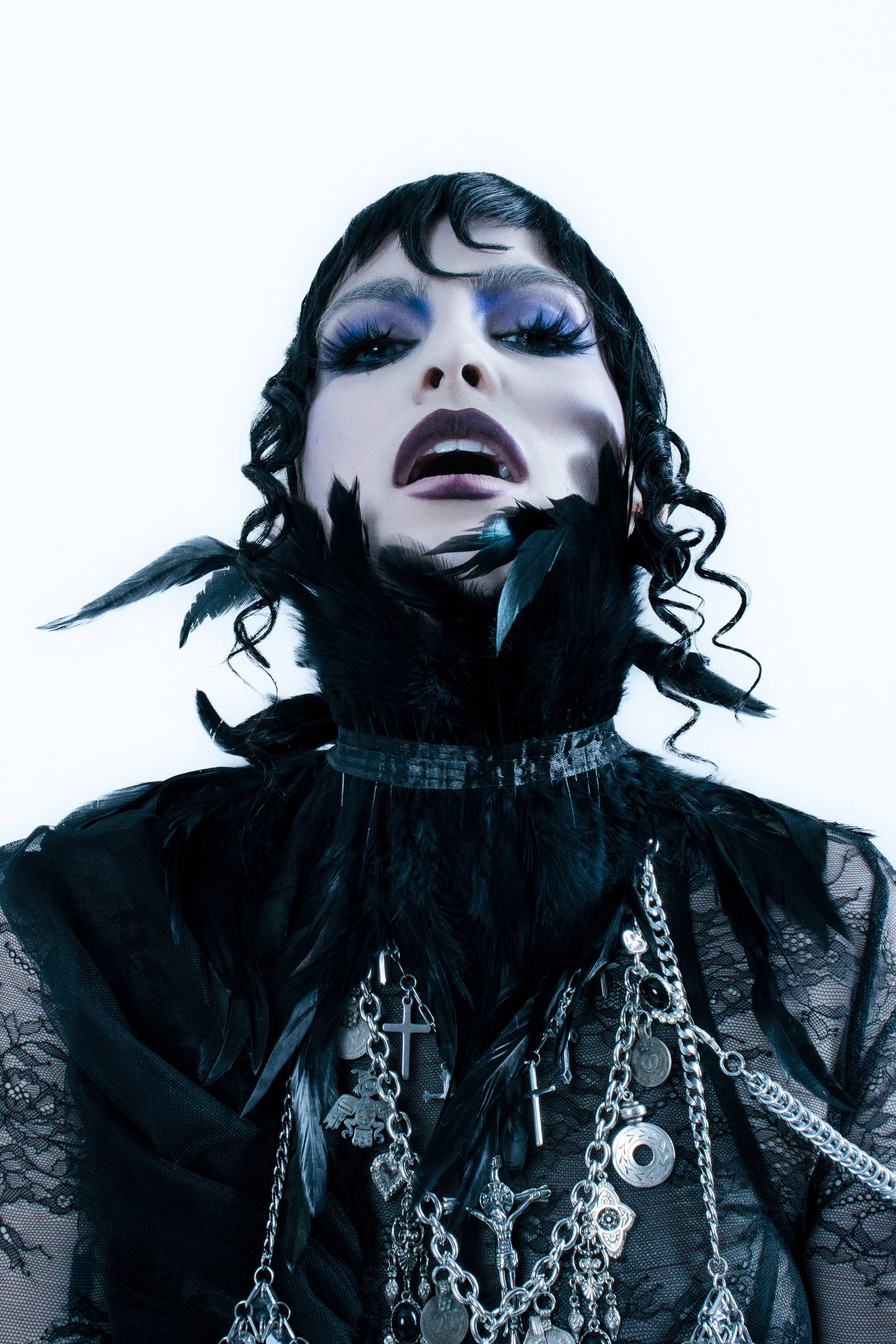   Abby Roberts wears, Dress: De La Vali, Over Dress: Iris Wang, Chainmail &amp; Shoulder Chain: Aesthetic Bullet, Necklace: Eras of Mystique, Feathers: Stylist Own  