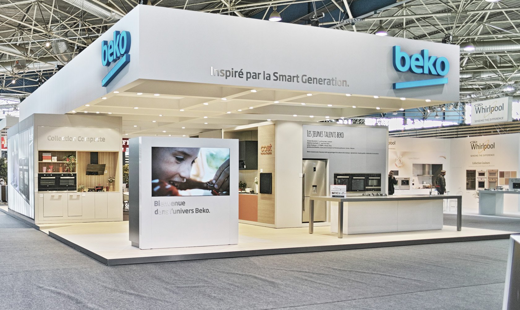 Beko exhibition booth at a trade show, featuring appliances and a large digital display, with the Beko logo and slogan in French.