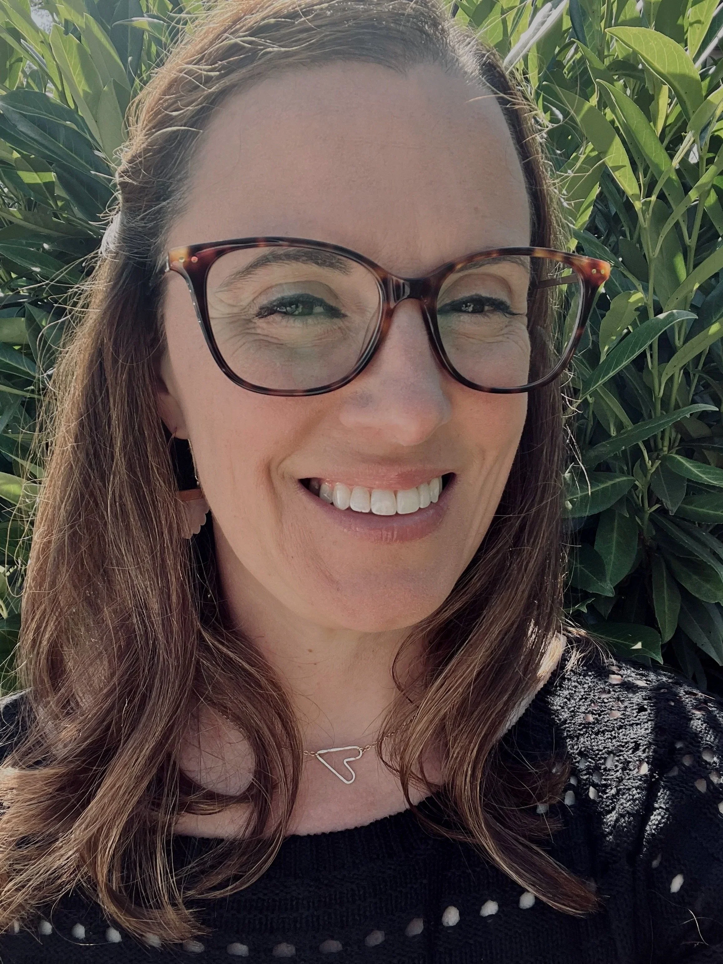 woman with shoulder length brown hair and glasses