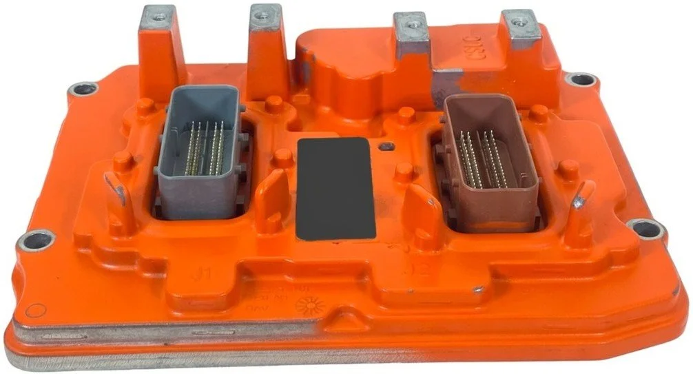 Orange automotive electronic control module with two rectangular connector ports containing multiple pins, mounted on a white background.