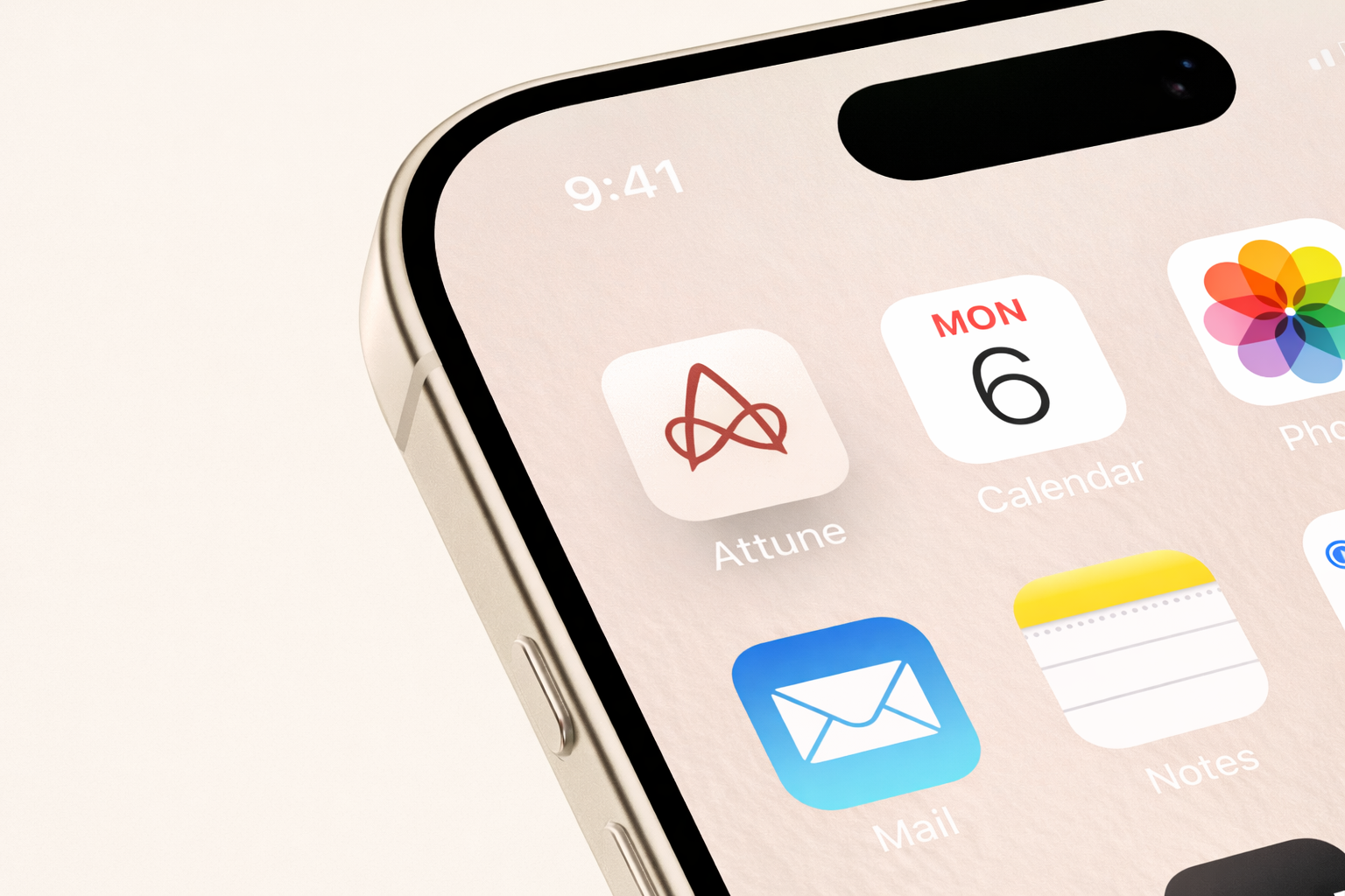 Close-up of an iPhone screen showing the Mail app, Calendar app, and Photos app icons on a light background.