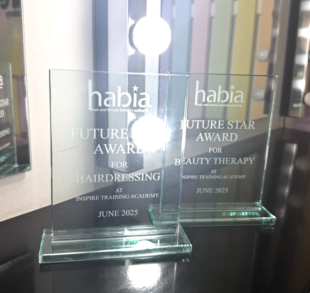 Two glass awards with engraved text recognizing Future Star Award for Hairdressing and Beauty Therapy at Inspire Training Academy, June 2025.