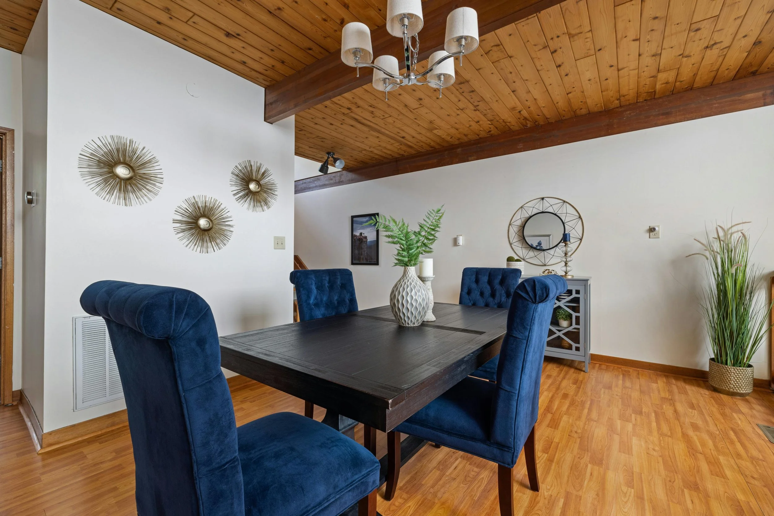 Modern, relaxing dining room in CT/NY home with wood paneled ceiling and cozy furniture.