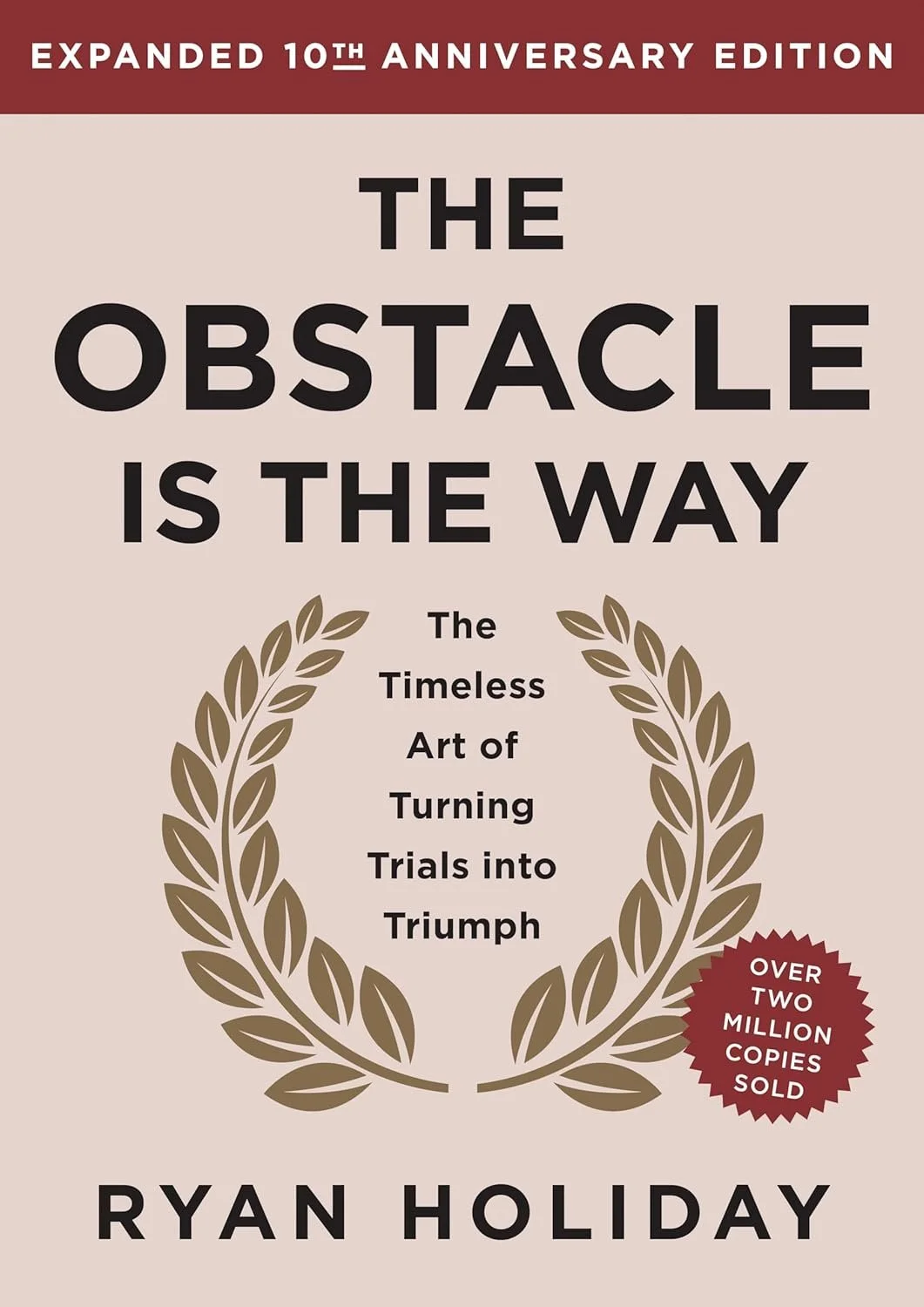 Book cover for 'The Obstacle is the Way' by Ryan Holiday, 10th anniversary edition, featuring a laurel wreath and a badge indicating over two million copies sold.