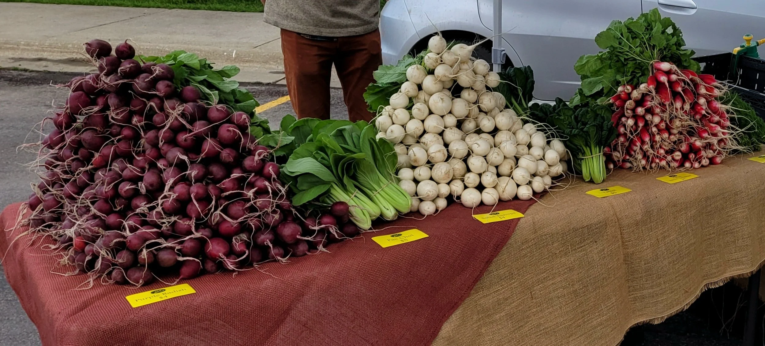 A large pile of red beets on a table at the Kalispell Farmers Market