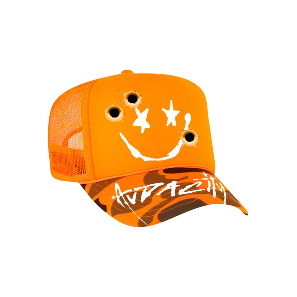 Orange baseball cap with a smiley face design, featuring bullet holes as eyes and nose.