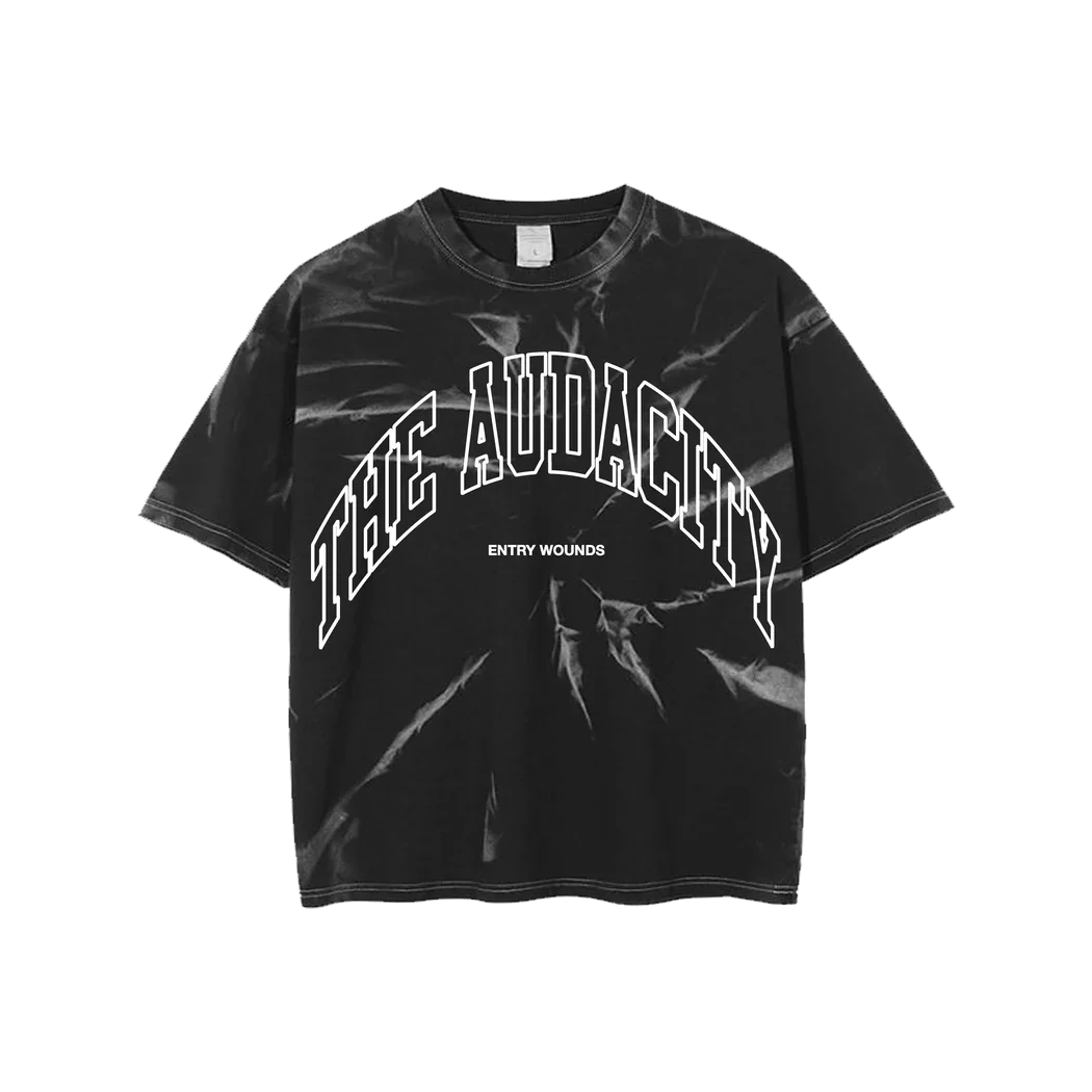 Black T-shirt with white text that reads 'THE AUDACITY' and smaller text 'ENTRY WOUNDS' underneath.