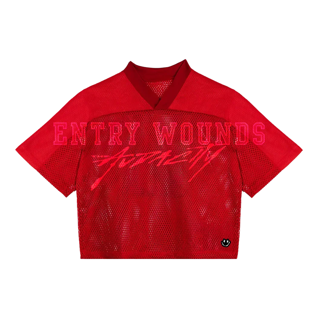 Red mesh short-sleeve shirt with text 'ENTRY WOUNDS' and 'FOTFLY' printed on it, and a small black abstract logo at the bottom right.