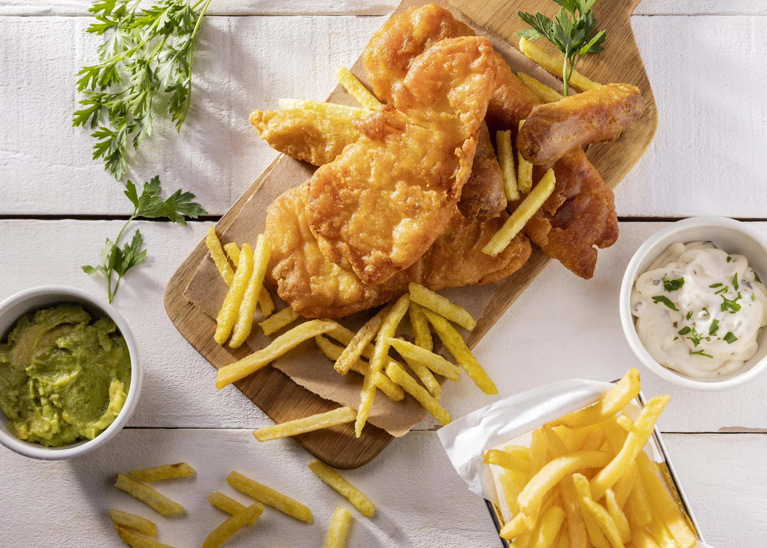 flat-lay-fish-chips-chopping-board-with-sauce.jpg