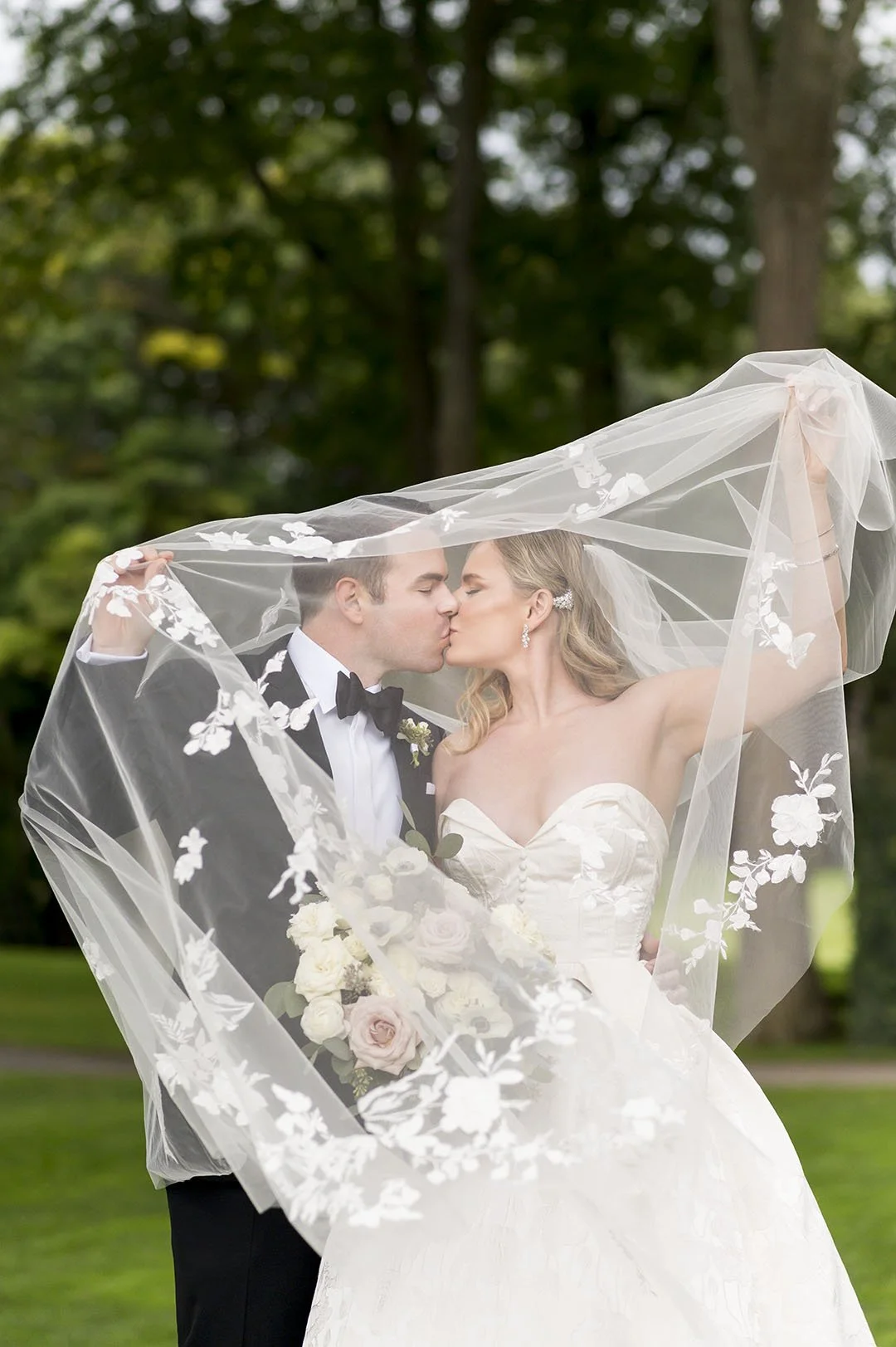 bride and groom under veil