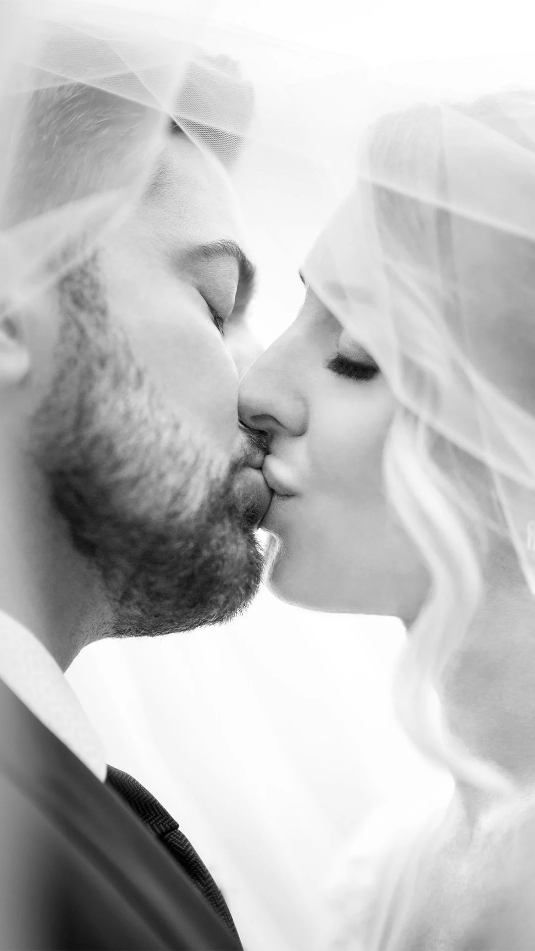 Bride and Groom Veil Kiss