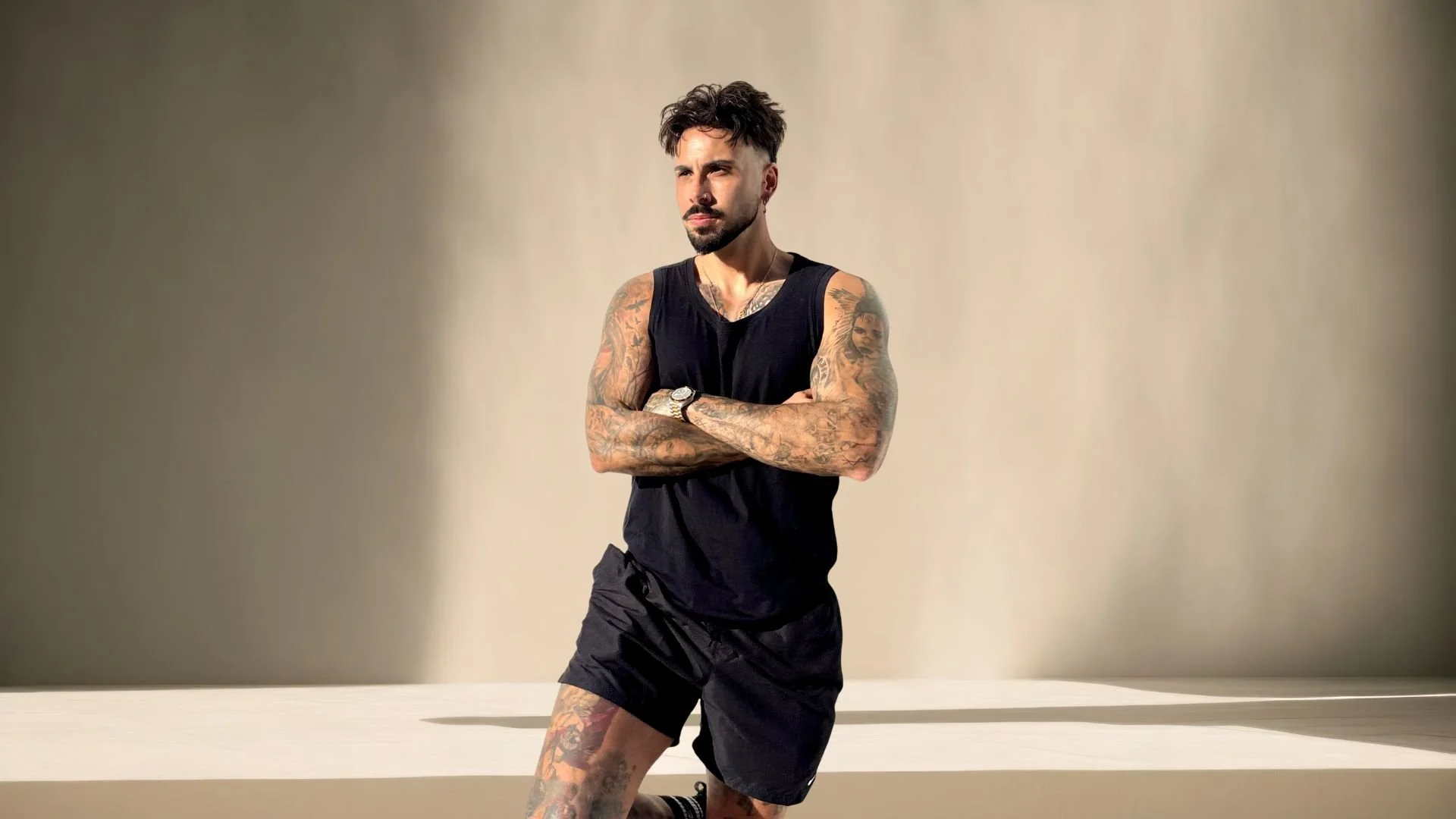 Joao from ONETRIBE standing in black athletic apparel representing Type 1 diabetes fitness coaching and lifestyle performance