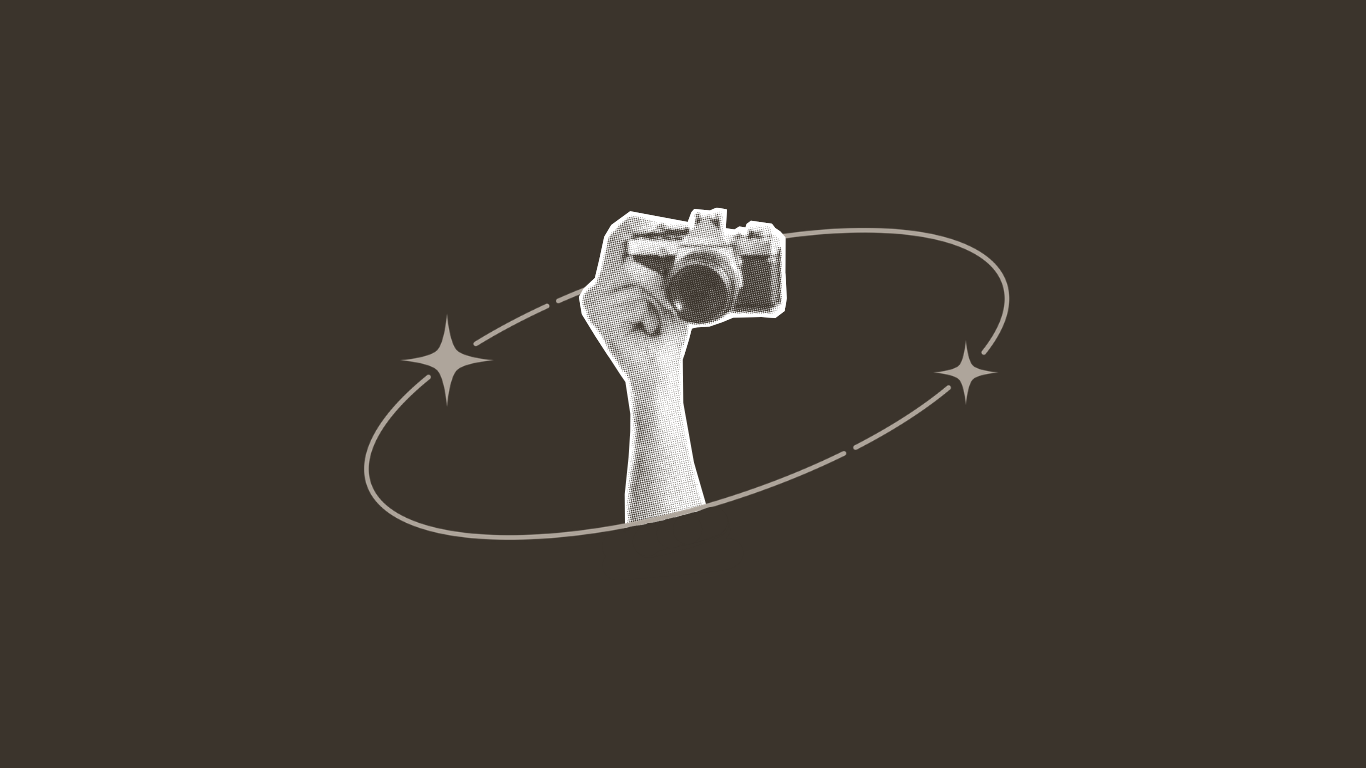 Illustration of a hand holding a camera, surrounded by a celestial orbit with two stars, on a dark background.