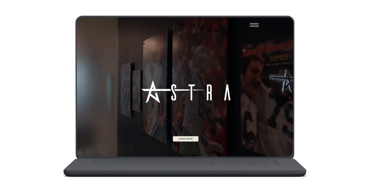 Laptop screen displaying the logo and website for Astro, with a background of sports memorabilia, including a football player and a person in sports gear, and a "Learn More" button.