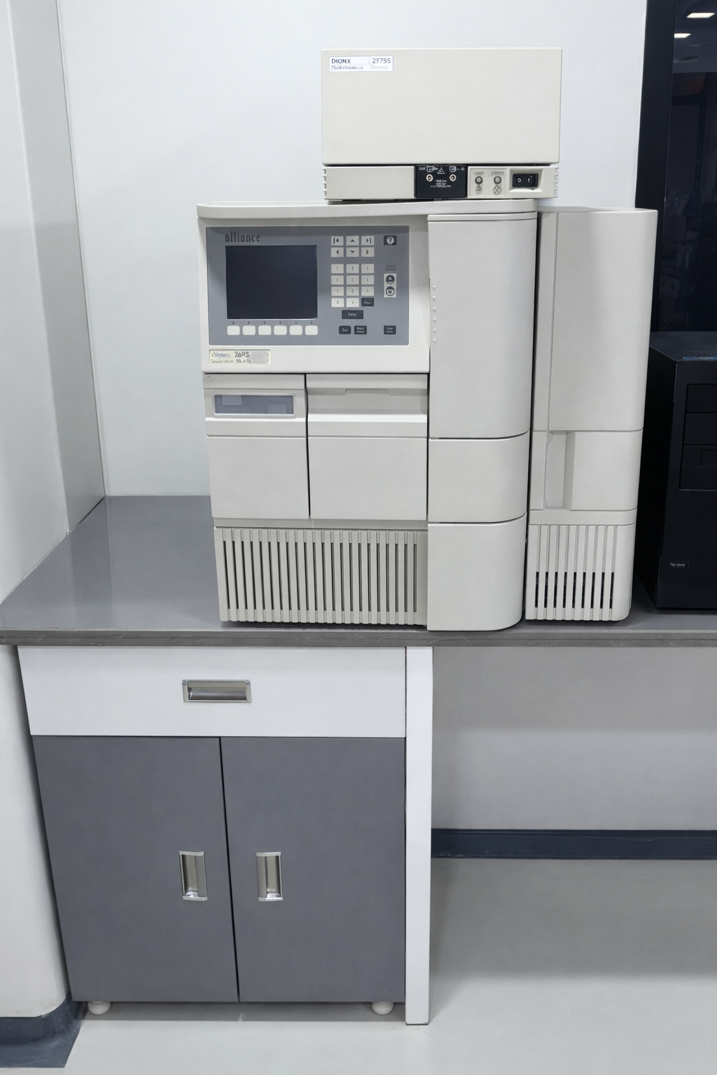 A medical laboratory analyzer machine sitting on a countertop in a lab setting.